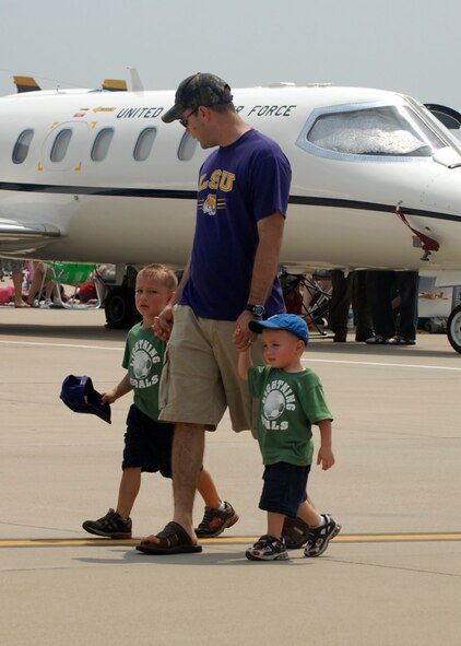 BARKSDALE AIR FORCE BASE, La -- Capt Drew Baird of the 93rd Bomb Squardon, and his sons, Nathan and AJ, walk toward displays on the flight line at the 2008 Defenders of Liberty Air Show here May 10.  (U.S. Air Force photo by A1C Brittany Y. Bateman) 