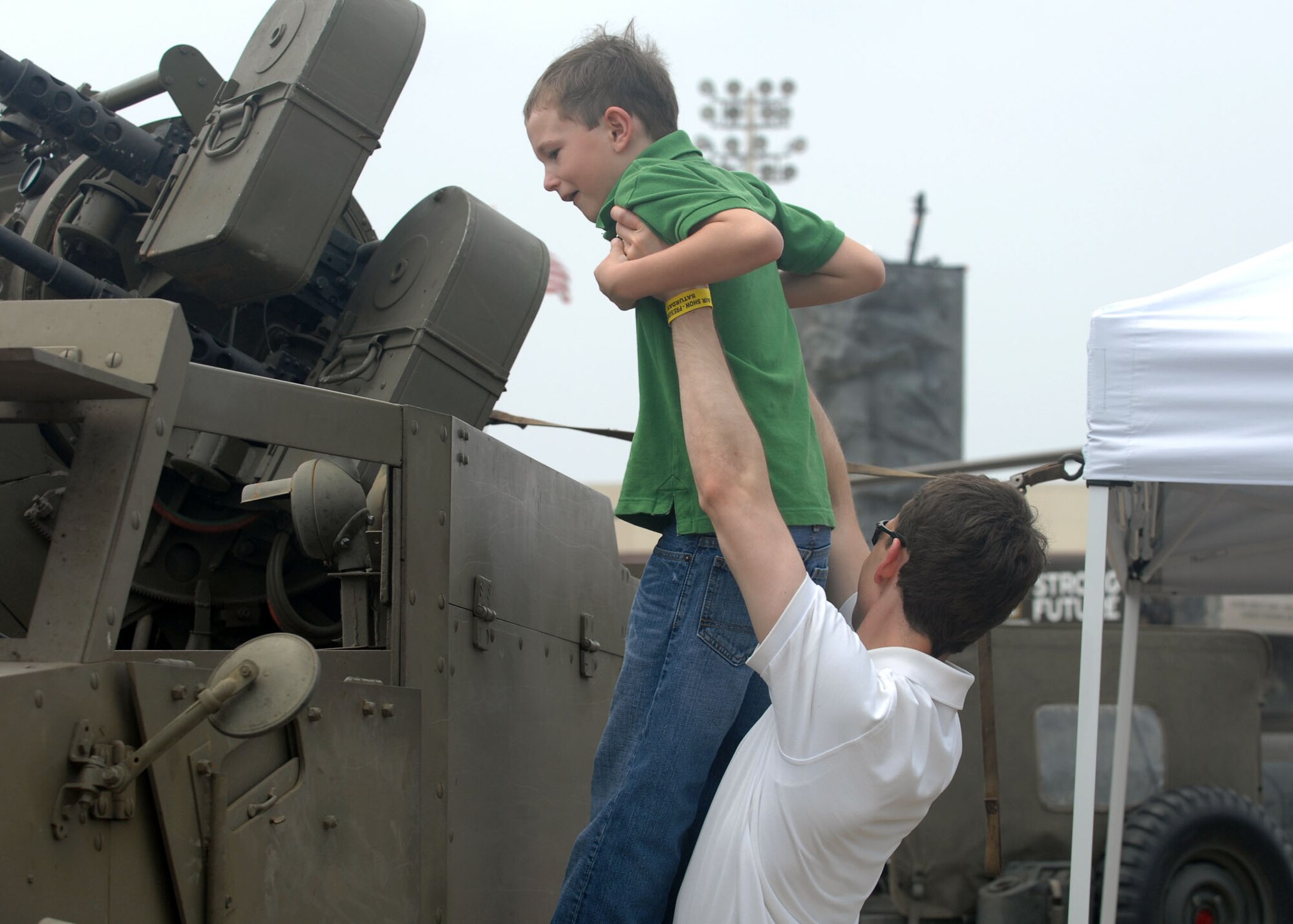 BARKSDALE AIR FORCE BASE, La -- Alexander Shultz lifts his son, Ben Schultz, 7, so he could look inside the Army tactical vehicle during the 2008 Defenders of Liberty Air Show here May 10. (U.S. Air Force photo by A1C Brittany Y. Bateman) 
