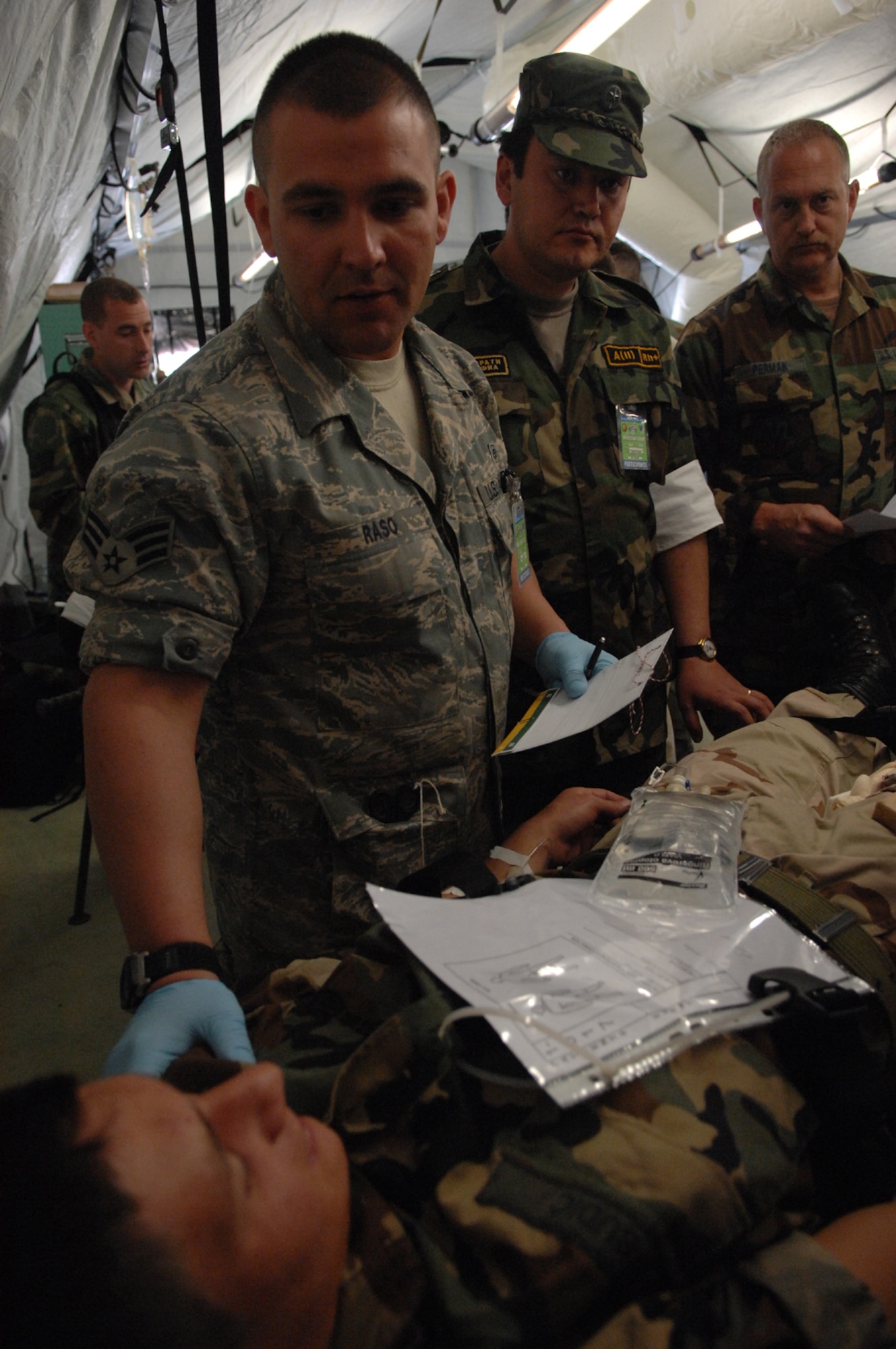 DIVULJE TRAINING BASE, Croatia – U.S. Air Force Senior Airman Tim Raso, a medical service journeyman with the 458th Expeditionary Medical Squadron, checks the status of moulage patient Croatian Army Cadet Ivica Budic after a simulated earthquake May 10 during the 2008 Medical Training Exercise in Central and Eastern Europe (MEDCEUR).  The simulated earthquake is part of a mass-casualty exercise to apply the knowledge troops gained during MEDCEUR training.  Fifteen nations are participating in the exercise from May 2 through 14. The exercise focuses on mass-casualty training scenarios and humanitarian aid in response to crises situations. MEDCEUR is a Joint Chiefs of Staff regional/multilateral exercise sponsored by U.S. European Command. Croatia is hosting the 2008 exercise which has drawn about 400 multi-nationals in support of the Partnership for Peace initiative. (U.S. Air Force photo/Staff Sgt. Kristin Ruleau) 