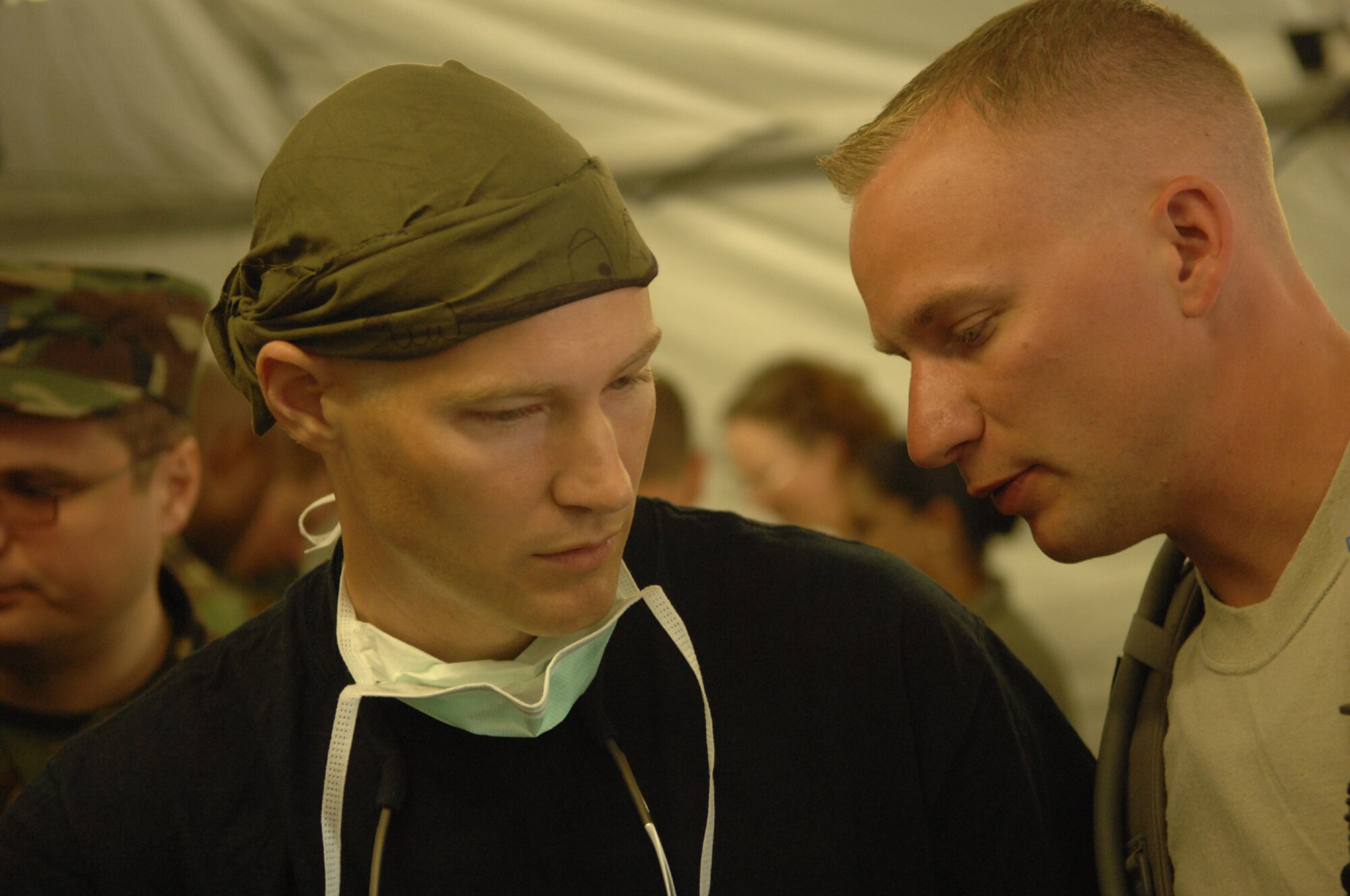 DIVULJE TRAINING BASE, Croatia – U.S. Air Force Maj. (Dr.) Michael Petro consults with Staff Sgt. Chris Endres, a medical service craftsman with the 458th Expeditionary Medical Squadron, about the status of incoming moulage patients after a simulated earthquake May 10 during the 2008 Medical Training Exercise in Central and Eastern Europe (MEDCEUR).  The simulated earthquake is part of a mass-casualty exercise to apply the knowledge troops gained during MEDCEUR training.  Fifteen nations are participating in the exercise from May 2 through 14. The exercise focuses on mass-casualty training scenarios and humanitarian aid in response to crises situations. MEDCEUR is a Joint Chiefs of Staff regional/multilateral exercise sponsored by U.S. European Command. Croatia is hosting the 2008 exercise which has drawn about 400 multi-nationals in support of the Partnership for Peace initiative. (U.S. Air Force photo/Staff Sgt. Kristin Ruleau) 