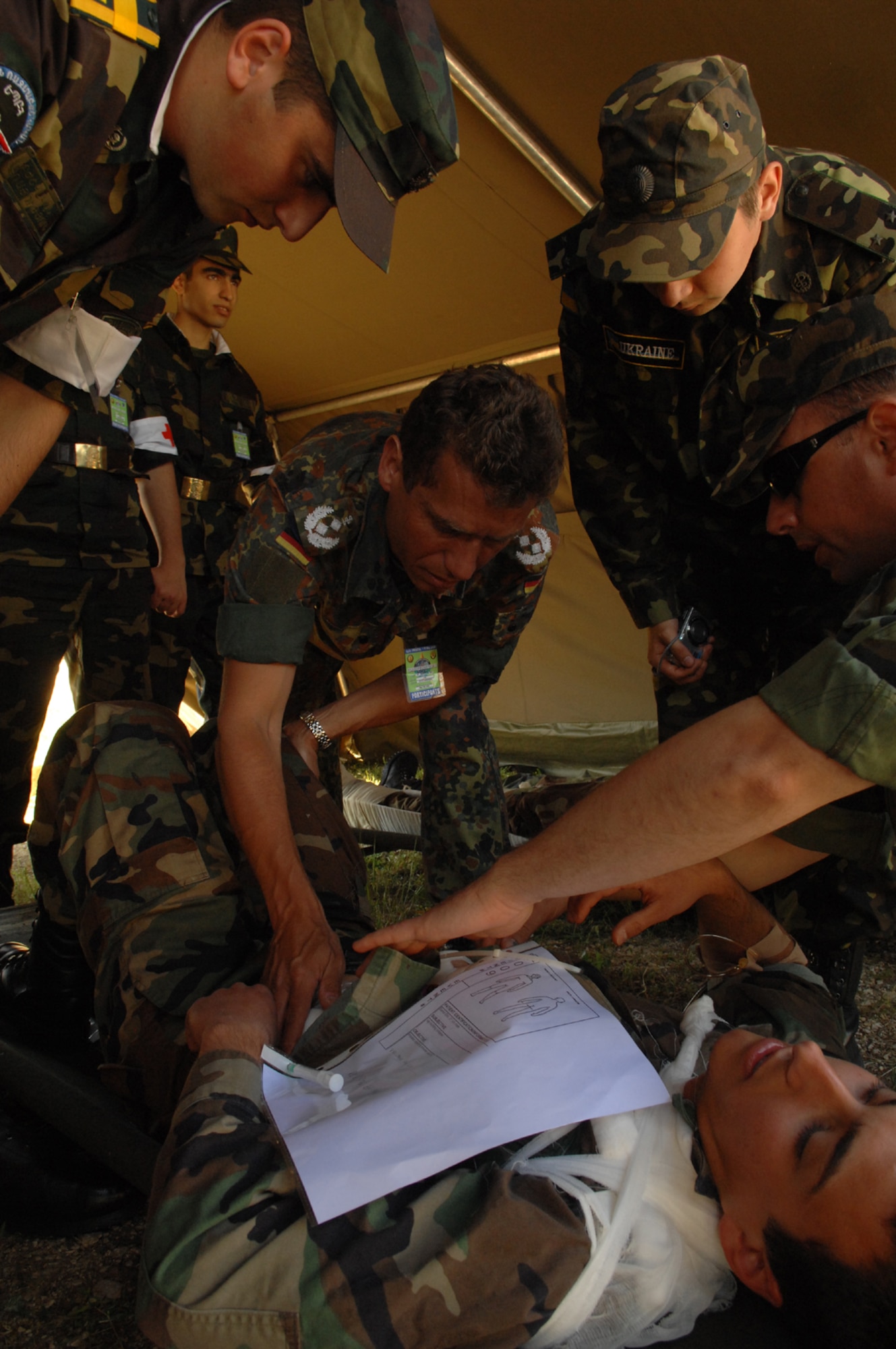 DIVULJE TRAINING BASE, Croatia – German Army Lt. Col. (Dr.) Christoph Otto triages moulage patient Croatian Army Cadet Frano Grljusic after a simulated earthquake May 10 during the 2008 Medical Training Exercise in Central and Eastern Europe (MEDCEUR).  The simulated earthquake is part of a mass-casualty exercise to apply the knowledge troops gained during MEDCEUR training.  Fifteen nations are participating in the exercise from May 2 through 14. The exercise focuses on mass-casualty training scenarios and humanitarian aid in response to crises situations. MEDCEUR is a Joint Chiefs of Staff regional/multilateral exercise sponsored by U.S. European Command. Croatia is hosting the 2008 exercise which has drawn about 400 multi-nationals in support of the Partnership for Peace initiative. (U.S. Air Force photo/Staff Sgt. Kristin Ruleau) 