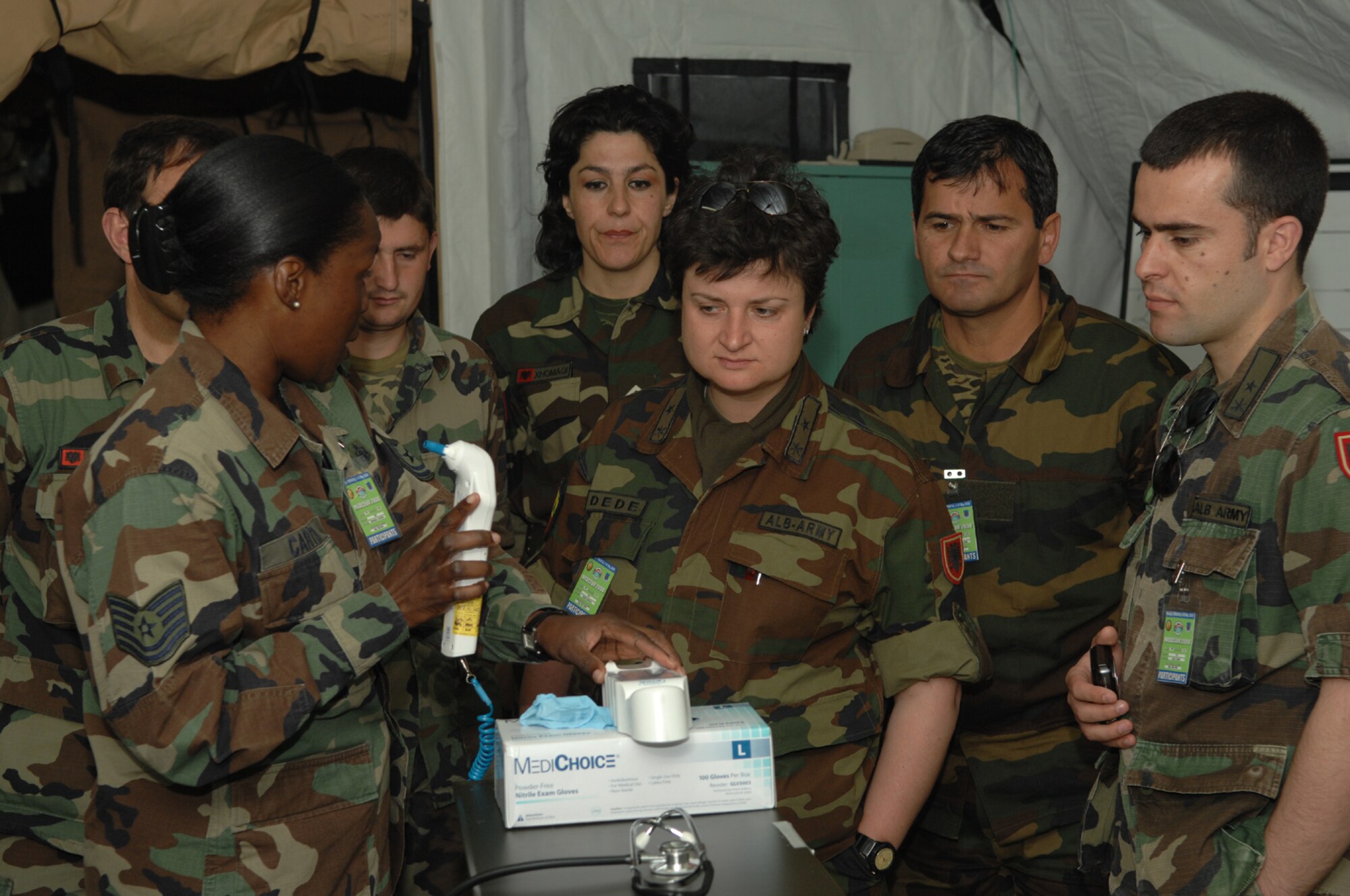 DIVULJE TRAINING BASE, Croatia – U.S. Air Force Tech. Sgt. Amanda Carter, 458th Expeditionary Medical Squadron, shows equipment contained in the Expeditionary Medical Support (EMEDS) package to fellow medics May 9. Fifteen nations are participating in the 2008 Medical Training Exercise in Central and Eastern Europe (MEDCEUR) from May 2 through 14. The exercise focuses on mass-casualty training scenarios and humanitarian aid in response to crises situations. MEDCEUR is a Joint Chiefs of Staff regional/multilateral exercise sponsored by U.S. European Command. Croatia is hosting the 2008 exercise which has drawn about 400 multi-nationals in support of the Partnership for Peace initiative. (U.S. Air Force photo/Staff Sgt. Kristin Ruleau)