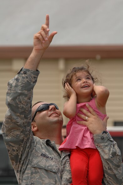 BARKSDALE AIR FORCEC BASE, La. -- Capt Daniel Agliata points out an aircraft to his daughter Lia during the Defenders of Liberty Air Show held here May 10. This air show marks the 75th Anniversary of the base. (U.S. Air Force photo by Airman 1st Class Joanna M. Kresge)