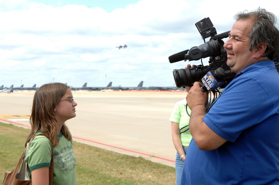 BARKSDALE AIR FORCE BASE, La. -- A reporter from Shreveport's KTAL news station interviews Katy Hall daughter of Cliff Hall from 2d Medical Group. In the interview Katy was asked what her favorite part of the show was, to which she replied 'how fast the planes were'.  (U.S. Air Force photo by Airman 1st Class Joanna M. Kresge)