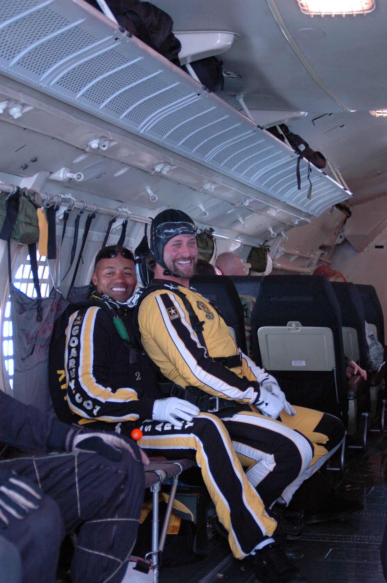 BARKSDALE AIR FORCE BASE, La. -- Staff Sergeant Marc Owens, U.S. Army Golden Knights Parachute Demonstration Team member, secures belts with Chris Brassard, Captain of the Bossier/Shreveport, La. Mudbugs hockey team, for their tandem jump during the Barksdale Defenders of Liberty Air show.  (U.S. Air Force Photo by Amn Allison M. Boehm)