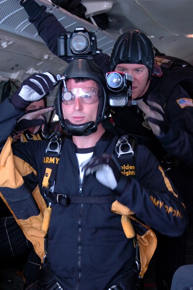 BARKSDALE AIR FORCE BASE, La. -- Sgt. Matthew Acord, U.S. Army Golden Knights Parachute Demonstration Team member, adjusts camera settings on his teammate’s equipment before a jump during a performance in the Barksdale Defenders of Liberty Air Show.  (U.S. Air Force Photo by Amn Allison M. Boehm)