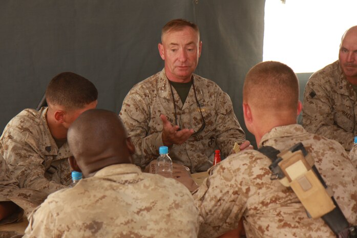 Lt. Gen. Samuel T. Helland talks with Marines with 2nd Battalion, 7th Marine Regiment, 1st Marine Division after eating a Meal Ready-to-Eat here. Helland, who is dual-hatted as the commander of U.S. Marine Corps Forces Central Command and commanding general of I Marine Expeditionary Force was one of four generals who came to see the troops during a one-week period. The battalion is in the process of mentoring, training and advising the Afghan National Police.