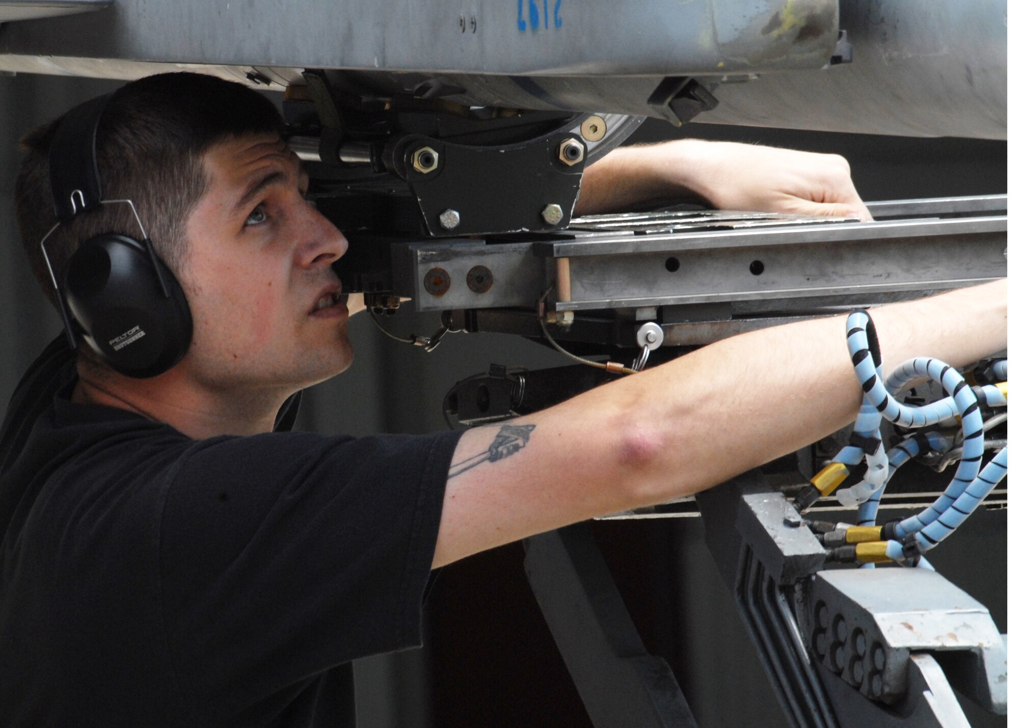 KUNSAN AIR BASE, Republic of Korea— Staff Sergant Lawrence Pyne, 35th Aircraft Maintenance Unit weapons load crew member, secures a bomb here May 10. (U.S. Air Force photo/Staff Sgt. Araceli Alarcon) 
