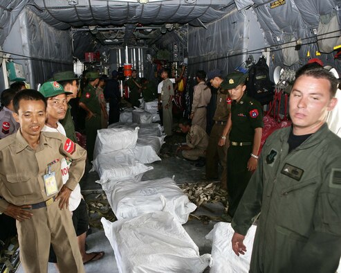 RANGOON, Burma-- Service members from Burma and United States pause momentarily while loading supplies from a U.S. Air Force C-130 onto Burmese trucks at the Rangoon International Airport, Burma, on May 12, 2008. The shipment of water, mosquito nets and blankets is the first of three planned flights in support of relief efforts following Tropical Cyclone Nagris that recently swept through Burma. (U.S. Marine Corps photo by Sgt. Andres Alcaraz) 