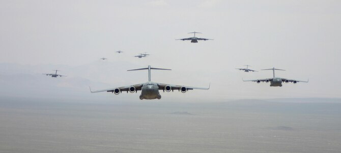 C-17A Globemaster III’s prepare for an airdrop over the Nevada Test Range during the U.S. Air Force Weapons School Mobility Air Forces Exercise here May 9. The Weapons School holds MAFEX twice a year to test the ability of C-17A Globemaster III and C-130 Hercules aircrews from 12 Air Force bases around the world to join together in a formation at a specific time and location to insert ground forces anywhere in the world. Thirteen C-17s and 15 C-130s took part in the MAFEX. (U.S. Air Force photo/Senior Airman Danielle Johnson)
