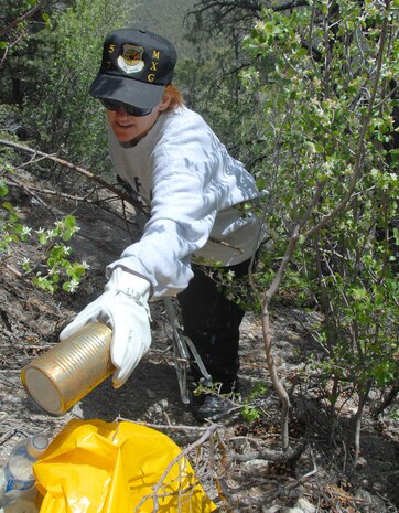 LAS VEGAS--Staff Sgt. Jackie Niemietz, 57th Maintenance Group, Nellis AFB, Nev., bags trash during the Spring Mountain Cleanup May 10. Volunteers clear trash and debris from campsites, roadways and trails from Spring Mountains National Recreation Area west of Las Vegas during the annual U.S. Forest Service sponsored event.  More than 40 Nellis and Creech AFB Airmen and family members took part in this year's event.  (U.S. Air Force photo/Chief Master Sgt. Gary Emery)