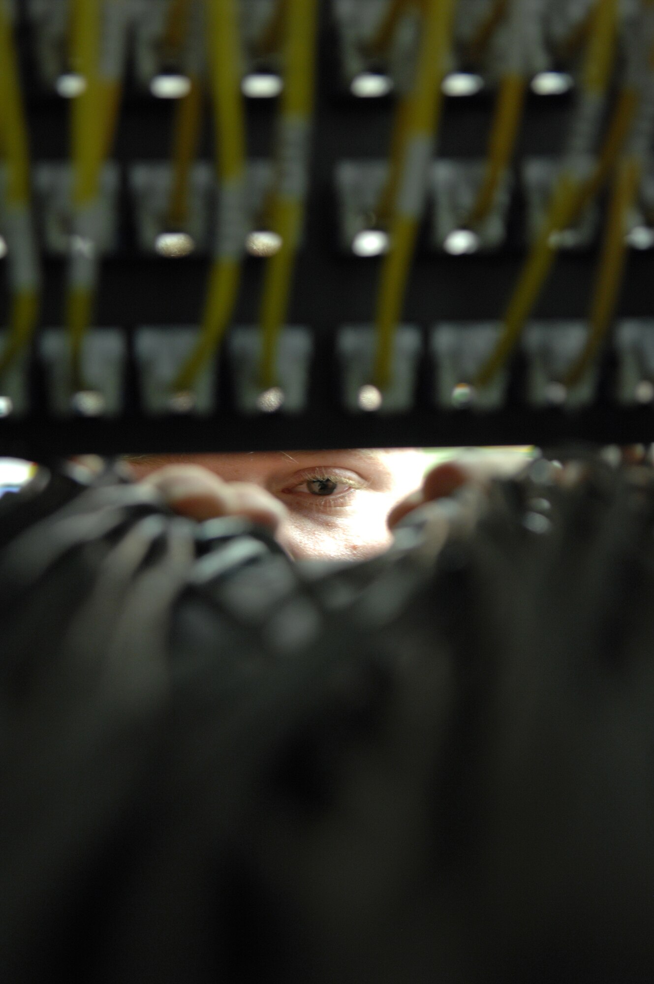 Senior Airman Etheridge, traces Cat-5 cable from the existing patch panel at Holloman Air Force Base, N.M. May 05. SrA Etheridge is an infrastructure technician assigned to the 49th Communications Squadron.
(U.S. Air Force photo/ Senior Airman Anthony Nelson Jr)  
