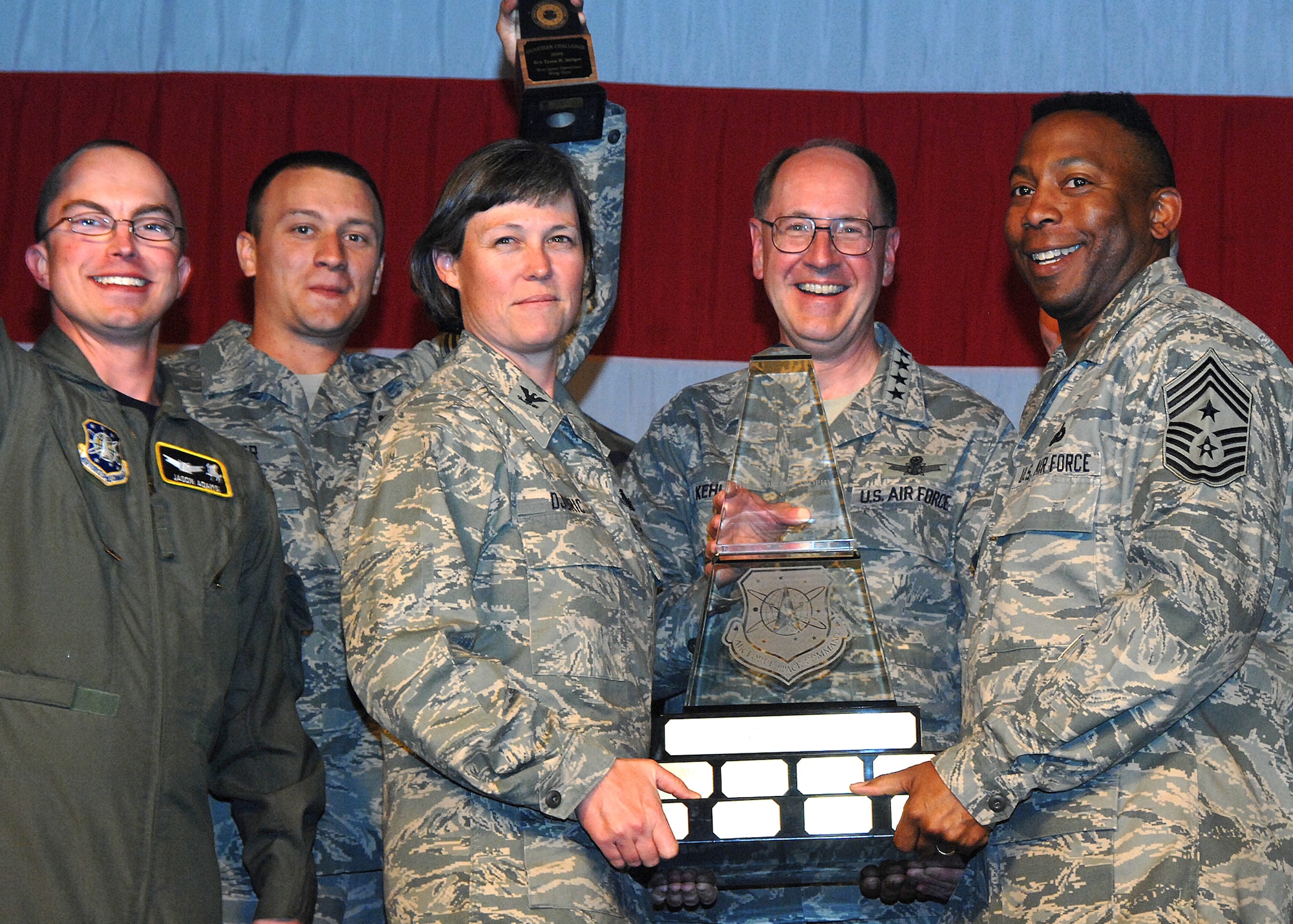 Members of the Guardian Challenge team from the 50th Space Wing at Schriever Air Force Base, Colo., celebrate their Aldridge Trophy win here May 9 naming them the Best Space Operations Wing in Air Force Space Command. Guardian Challenge is the Air Force's premier space and missile competition.  The award presentation took place at Peterson AFB, Colo.  (U.S. Air Force photo/Duncan Wood)