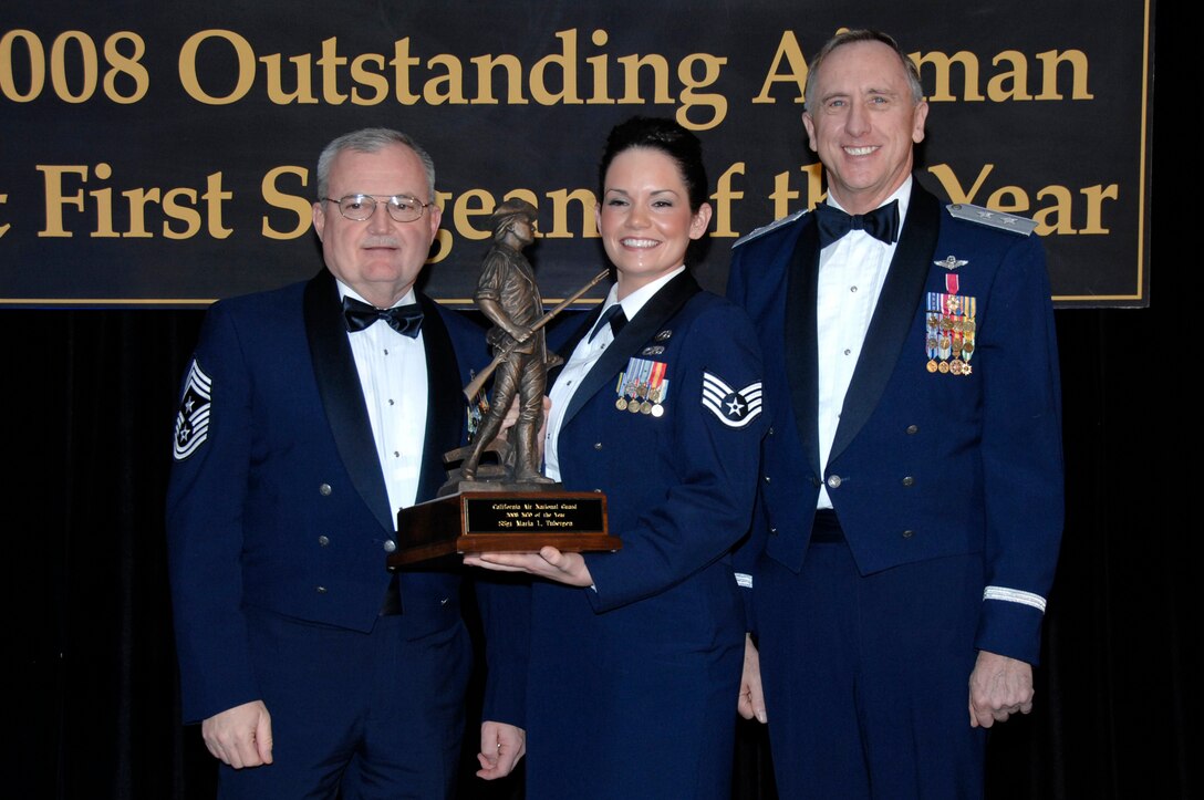 Staff Sgt. Maria Tubergen from the 129th Rescue Wing beams upon receipt of the California Air National Guard's Non-Commissioned Officer of the Year award.  She was presented with the award at the annual Outstanding Airman of the Year banquet in San Jose, Calif. Jan. 12 by Chief Master Sgt. Richard A. Smith. Command Chief Master Sergeant of the Air National Guard and Major Gen. Dennis Lucas, Commander of the California Air National Guard. (U.S. Air Force photo by Staff Sgt Andrew Hughan)