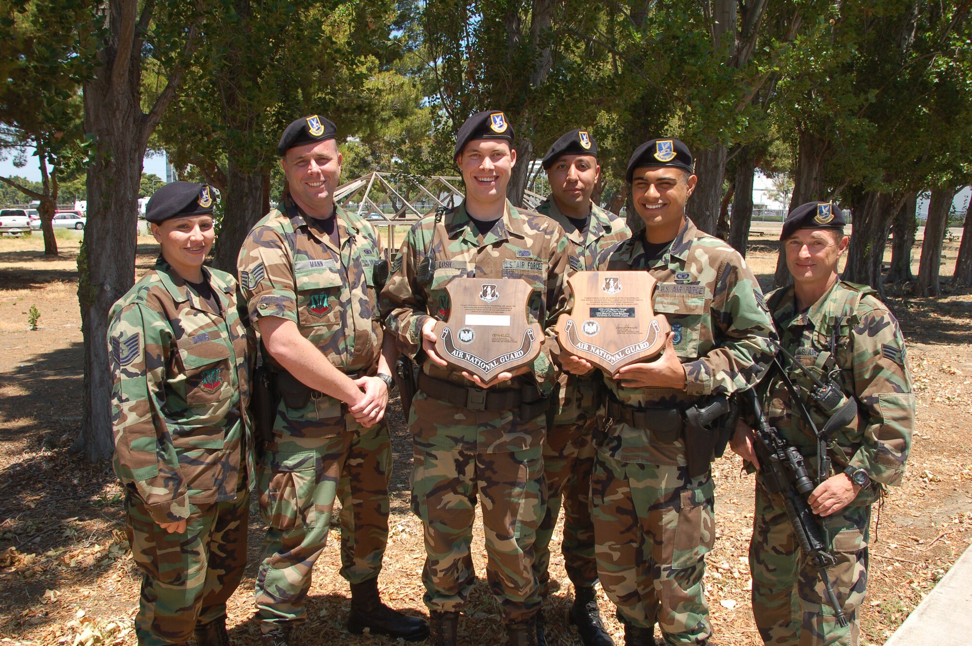 129th Security Forces members Tech. Sgt. Maricela Davis, Staff Sgt. Sean Mann, Senior Airman Allen Losh, Senior Airman Richard Rodriguez, Senior Airman Chris Wilton and Senior Airman Larry Anderson hold the plaques awarding the 129th SFS the ANG Outstanding Security Forces Squadron for 2005 and 2006. (U.S. Air Force photo/Staff Sgt Andrew Hughan)