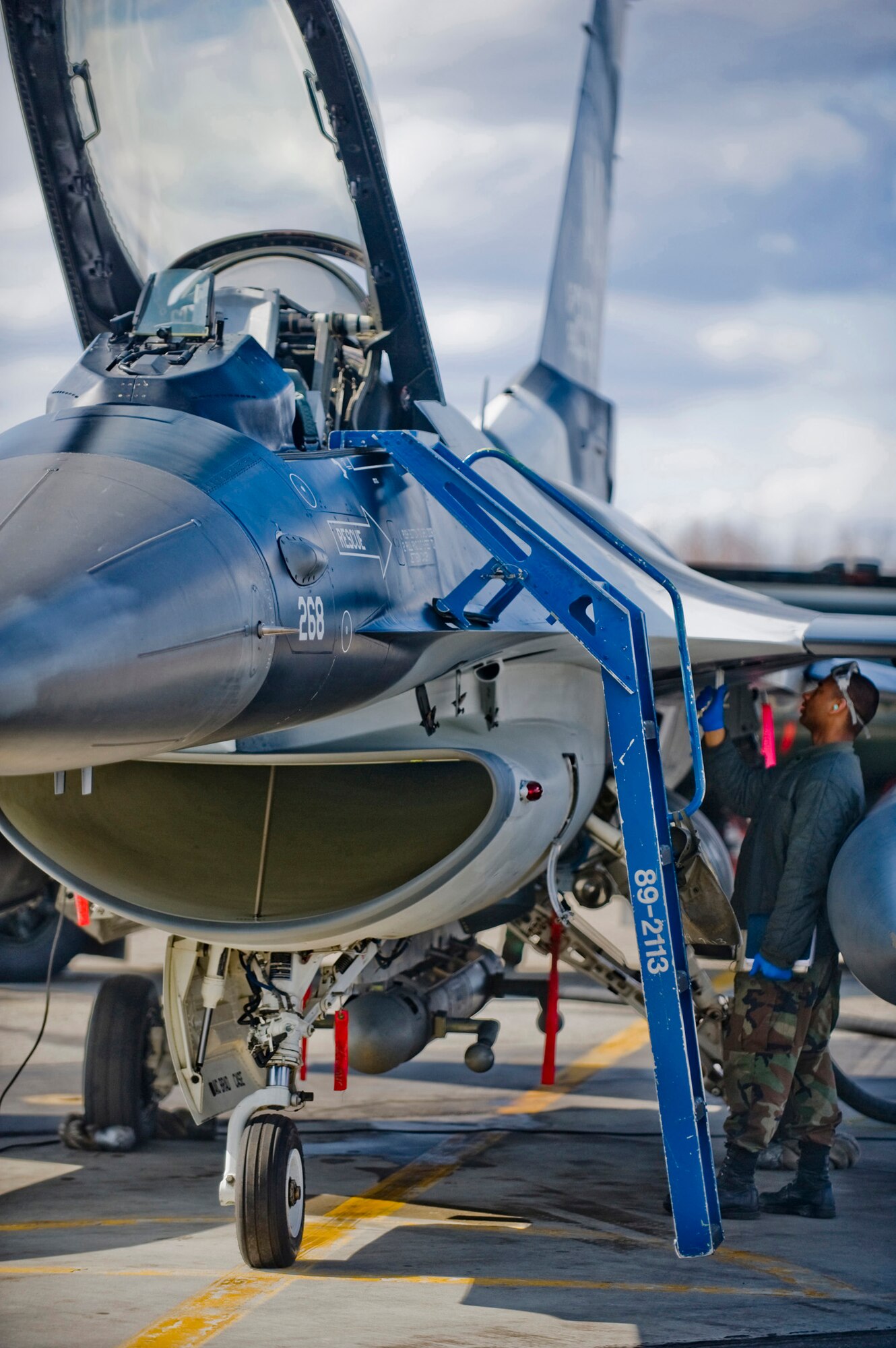 Airman 1st Class Kyle Hughes, 354th Aircraft Maintenance Squadron crew chief, inspects an 18th Aggressor Squadron F-16 at Eielson Air Force Base, Alaska on May 8, 2008. The 18th Aggressor Squadron is participating in Northern Edge, simulating enemy aircraft from various countries in order to allow joint forces to train for world wide crises. (U.S. Air Force Photo by Airman 1st Class Jonathan Steffen)