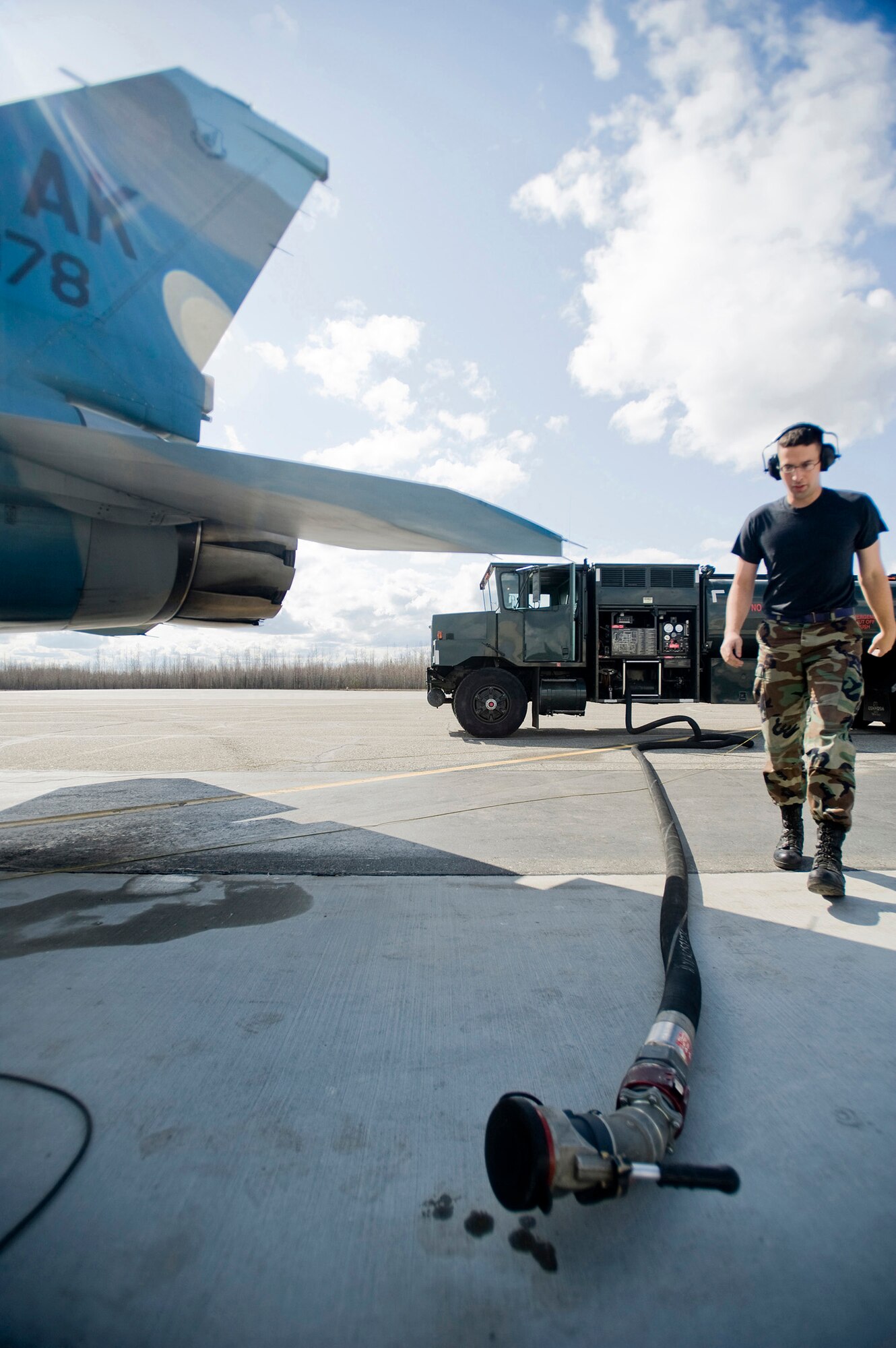 Airman 1st Class Aaron Orr, 374th Logistic Readiness Squadron, walks along a fuel hose used to gas up the F-16 18th Aggressor Squadron from Eielson Air Force Base, Alaska on May 8, 2008. The 18th Aggressor Squadron is participating in Northern Edge, simulating enemy aircraft from various countries in order to allow joint forces to train for world wide crises. (U.S. Air Force Photo by Airman 1st Class Jonathan Steffen) 
