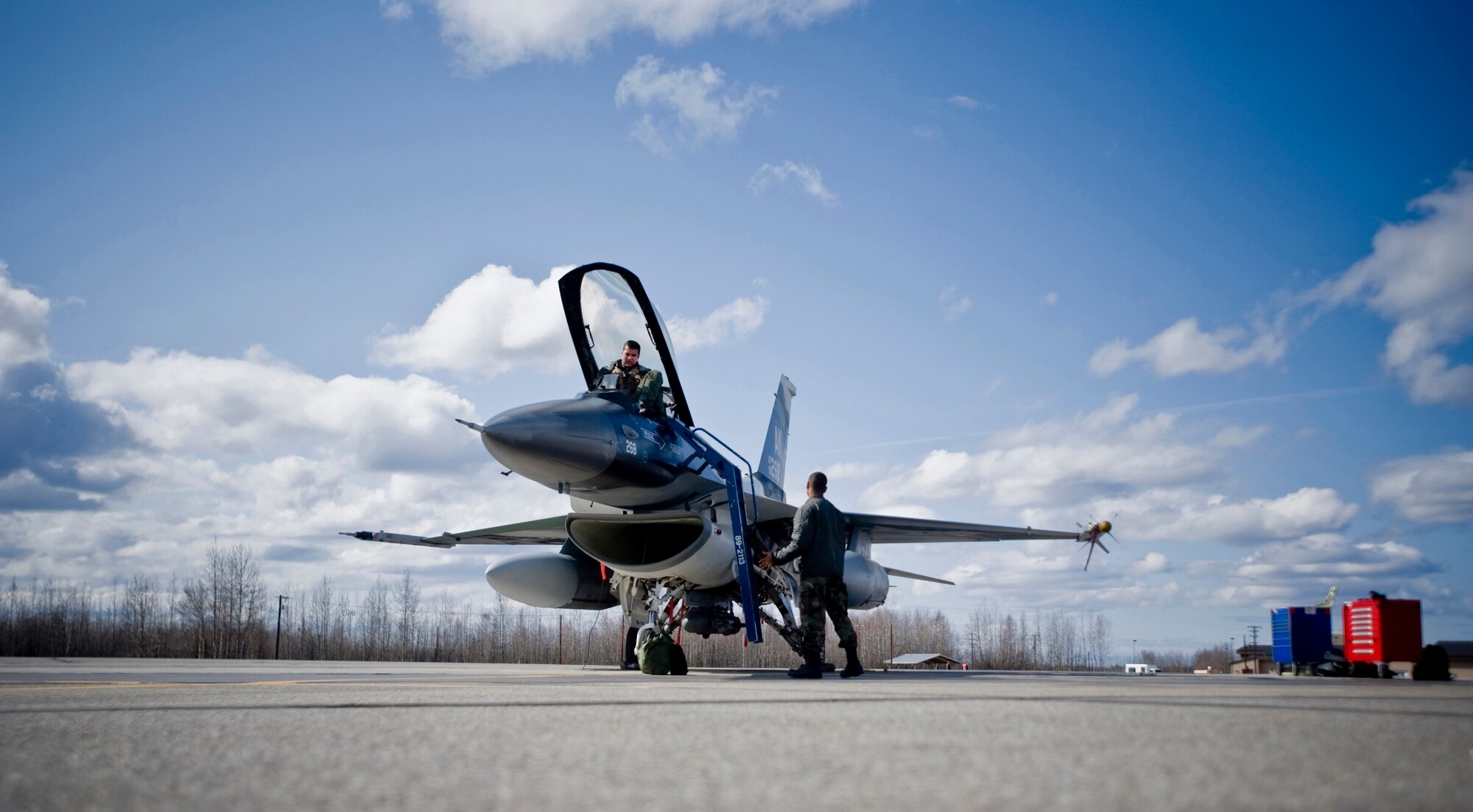 Airman 1st Class Kyle Hughes, 354th Aircraft Maintenance Squadron crew chief, attaches a ladder to an 18th Aggressor Squadron F-16 at Eielson Air Force Base, Alaska on May 8, 2008. The 18th Aggressor Squadron is participating in Northern Edge, simulating enemy aircraft from various countries in order to allow joint forces to train for world wide crises. (U.S. Air Force Photo by Airman 1st Class Jonathan Steffen)