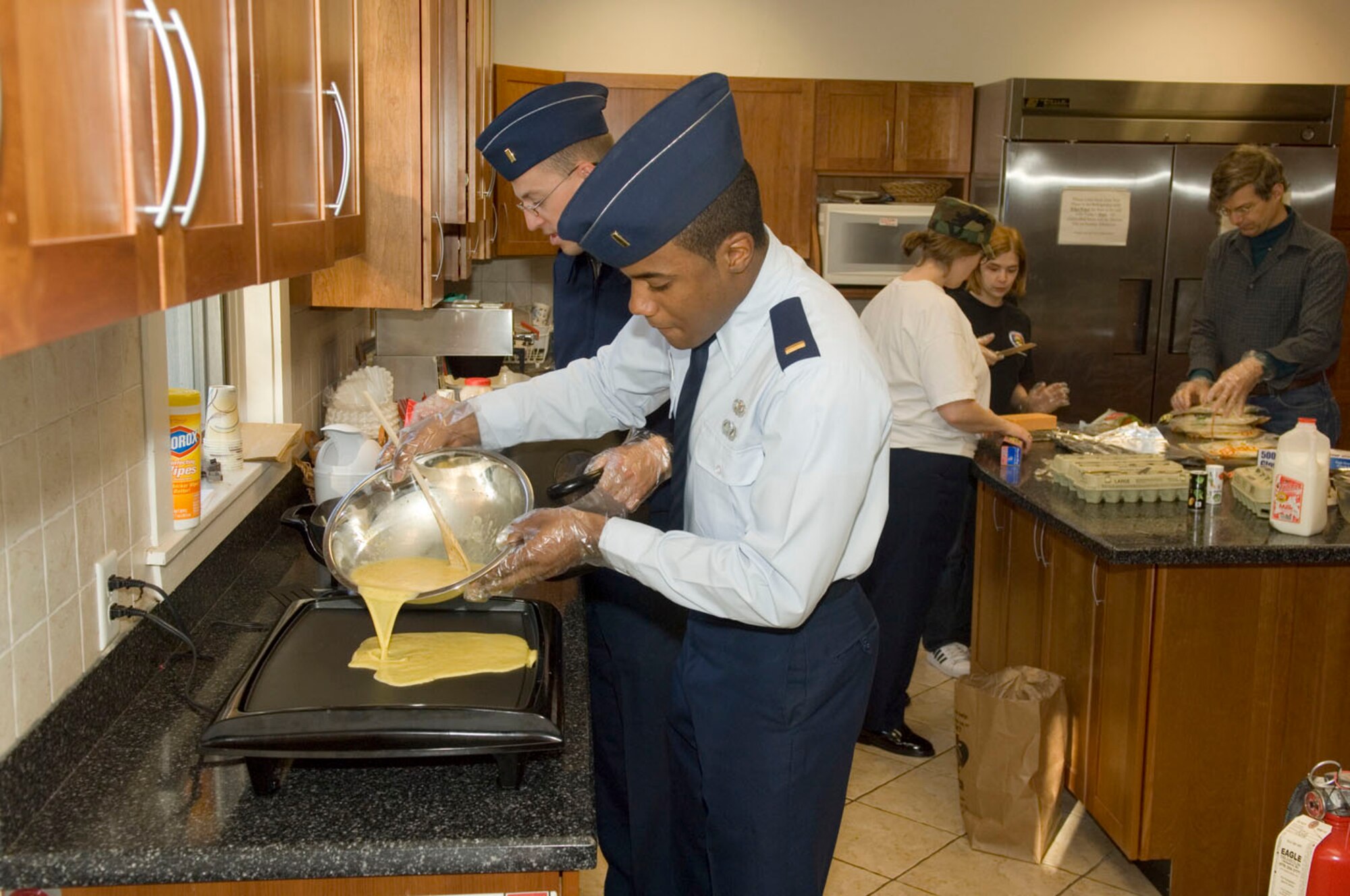 HANSCOM AFB, Mass. – Second Lt. Karl Artis III, 66th Mission Support Squadron, cooks eggs for a batch of breakfast burritos April 30 as part of an Air Force Assistance Fund fundraising event. Lieutenant Artis, along with other 66 ABW AFAF key workers, made more than 80 breakfast burritos and raised $250. As of May 6, Hanscom raised a total of $46,034 during the campaign, surpassing their original goal of $37,089. (U.S. Air Force photo by Rick Berry.)