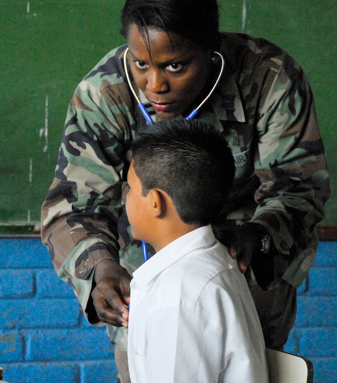 COMASAGUA, El Salvador ? Air Force Capt. Charlene Kirby examines a Salvadoran boy May 7 at a school near Comasagua, El Salvador, during Fuerzas Aliadas Humanitarias 2008, the U.S. Southern Command and Salvadoran Ministry of Defense-sponsored exercise held throughout the Central American region May 5-15. Captain Kirby was part of the 18-person team of Soldiers and Airmen from Soto Cano Air Base, Honduras, who spent two days operating a makeshift clinic at an elementary school triaging more than 1,600 Salvadoran villagers. (U.S. Air Force photo by Tech. Sgt. William Farrow)  