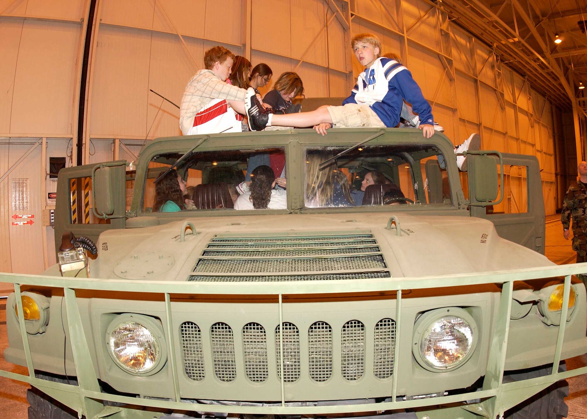 GRISSOM AIR RESERVE BASE, Ind., -- Miami County sixth graders take a break on top of a High Mobility Multipurpose Wheeled Vehicle, or HUMVEE. Approximately 460 children from Blair Point, North Miami, Maconaquah and St. Charles visited Grissom Monday to participate in a National Police Week event. The activities provided students an overview into both military and civil police capabilities and resources. (U.S. Air Force photo/Tech. Sgt. Doug Hays)                            