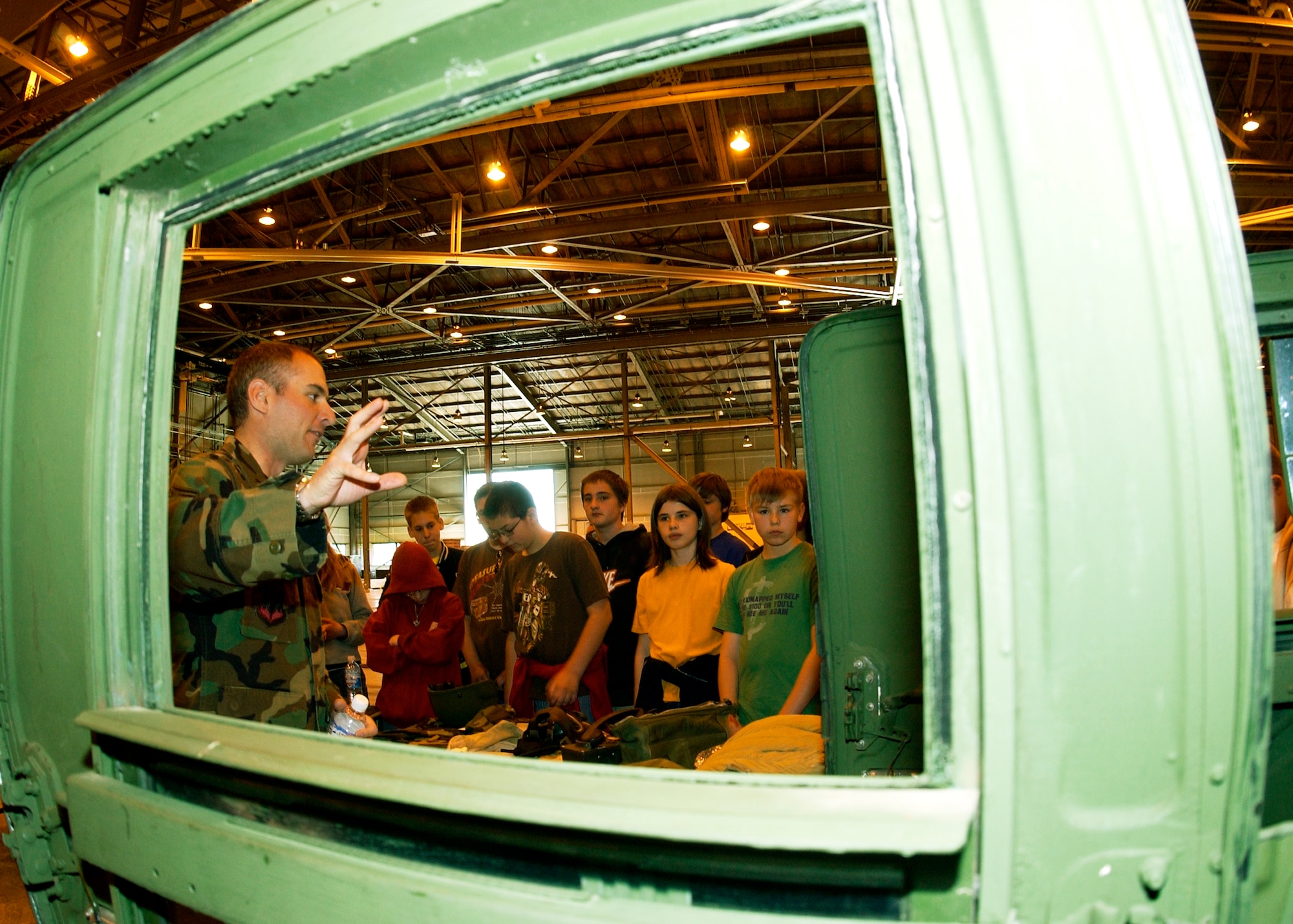 GRISSOM AIR RESERVE BASE, Ind., -- Senior Airman Alexander Harris, a fire team member with the 434th Security Forces Squadron, shares information about a High Mobility Multipurpose Wheeled Vehicle, or HUMVEE, with Miami County sixth graders. Approximately 460 children from Blair Point, North Miami, Maconaquah and St. Charles visited Grissom Monday to participate in a National Police Week event. (U.S. Air Force photo/Tech. Sgt. Doug Hays)