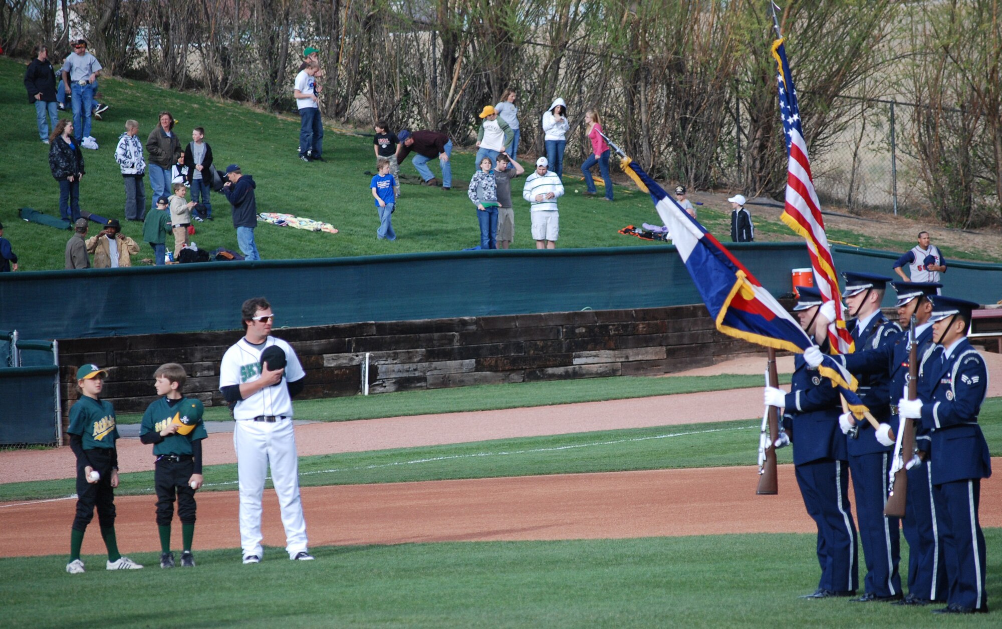 Members of the High Frontier Honor guard present the colors during the National Anthem at a Sky Sox game May 9. Col. Scott Shepherd, 21st Space Wing vice commander, and leadership from other Front Range bases threw out the ceremonial first pitches in honor of military appreciation night at the stadium. (U.S. Air Force photo/Staff Sgt. Jessica Switzer)