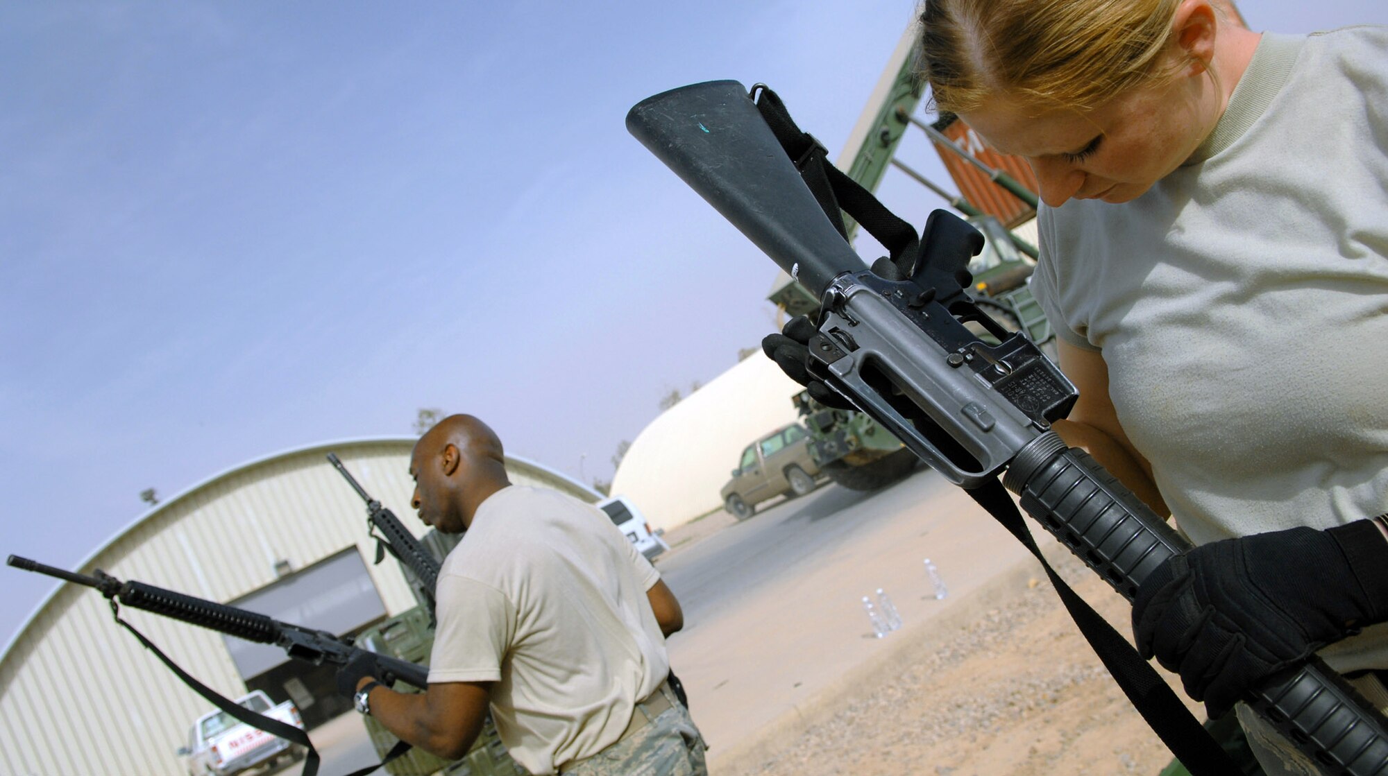 Master Sgt. Darryl Sterling and Senior Airman Lydia Hickey check serial numbers on M-16 rifles April 5 at Balad Air Base, Iraq. Both Airmen are deployed from Luke Air Force Base, Ariz. Sergeant Sterling and Airman Hickey are assigned to the 332nd Expeditionary Logistics Readiness Squadron. (U.S. Air Force photo/Senior Airman Julianne Showalter) 
