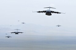 NELLIS AIR FORCE BASE, Nev.--C-17A Globemaster III’s prepare for an airdrop over the Nevada Test Range during the U.S. Air Force Weapons School Mobility Air Forces Exercise here May 9. The Weapons School holds MAFEX twice a year to test the ability of C-17A Globemaster III and C-130 Hercules aircrews from 12 Air Force bases around the world to join together in a formation at a specific time and location to insert ground forces anywhere in the world. Thirteen C-17s and 15 C-130s took part in the MAFEX. (U.S. Air Force photo/Master Sgt. Robert W. Valenca)
