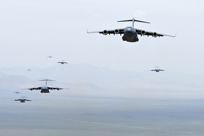 NELLIS AIR FORCE BASE, Nev.--C-17A Globemaster III’s prepare for an airdrop over the Nevada Test Range during the U.S. Air Force Weapons School Mobility Air Forces Exercise here May 9. The Weapons School holds MAFEX twice a year to test the ability of C-17A Globemaster III and C-130 Hercules aircrews from 12 Air Force bases around the world to join together in a formation at a specific time and location to insert ground forces anywhere in the world. Thirteen C-17s and 15 C-130s took part in the MAFEX. (U.S. Air Force photo/Master Sgt. Robert W. Valenca)