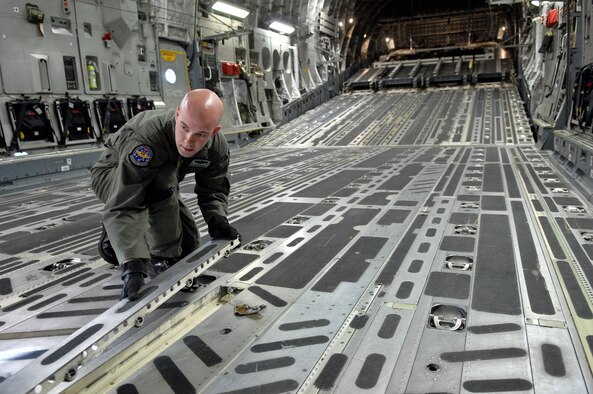 Tech. Sgt. Bryan Marvel, 57th Weapons Squadron, McGuire AFB, N.J., prepares a C-17 Globemaster III for a mission during the U.S. Air Force Weapons School Mobility Air Forces Exercise here May 9. The Weapons School holds MAFEX twice a year to test the ability of C-17A Globemaster III and C-130 Hercules aircrews from 12 Air Force bases around the world to join together in a formation at a specific time and location to insert ground forces anywhere in the world. (U.S. Air Force photo/Master Sgt. Robert W. Valenca) 