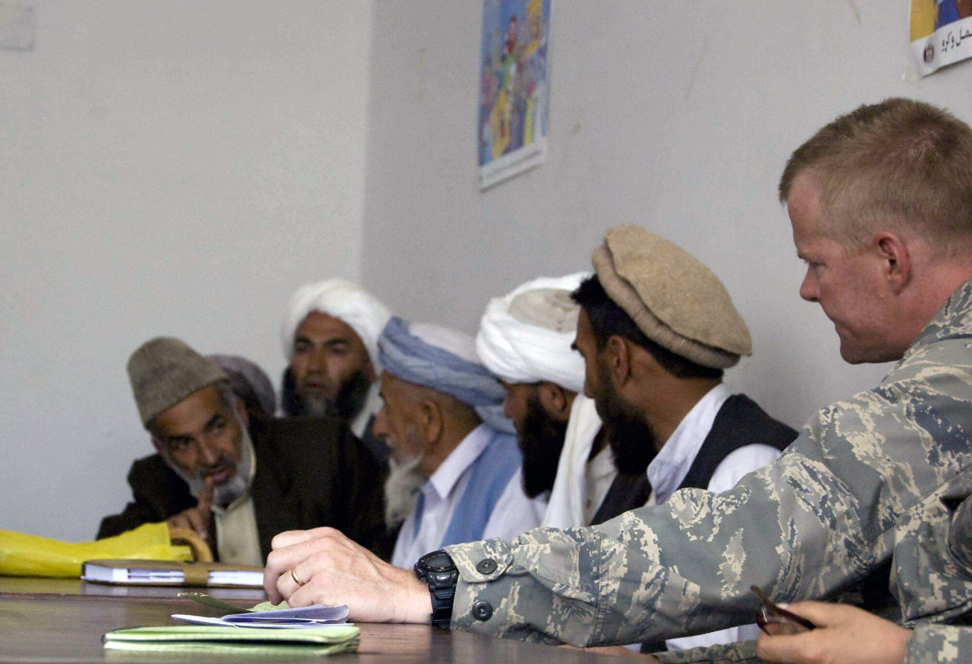 Lt. Col. David Poage listens intently to a village elder during a meeting with tribal leaders and elders May 4 at the Alishang District Center in the Laghman Province in Afghanistan. During the meeting, leaders discussed pressing issues and problems affecting the community. Colonel Poage is the commander of the Laghman Provincial Reconstruction Team. (U.S. Air Force photo)
