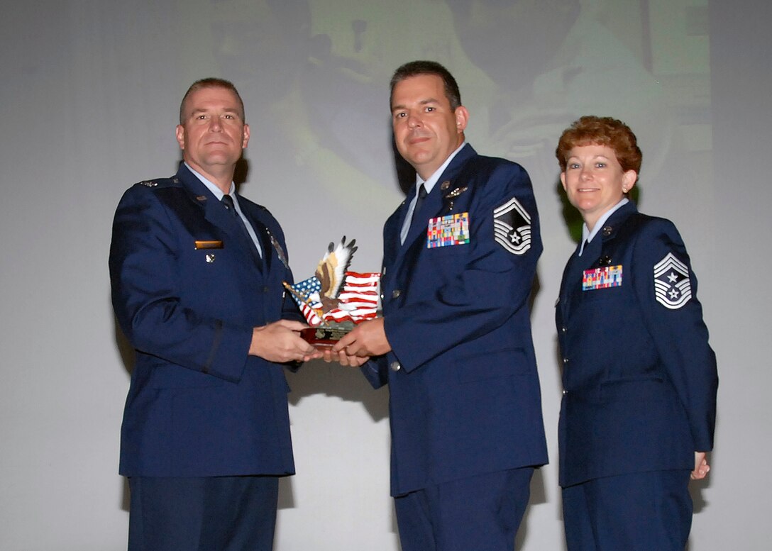 Col, Kris Beasley, 82nd Training Wing vice commander, presents Senior Master Sgt. Michael Stephenson-Pino, 882nd Training Group, with the Senior NCO of the Quarter, award May 6. (U.S. Air Force photo/Mike Litteken)