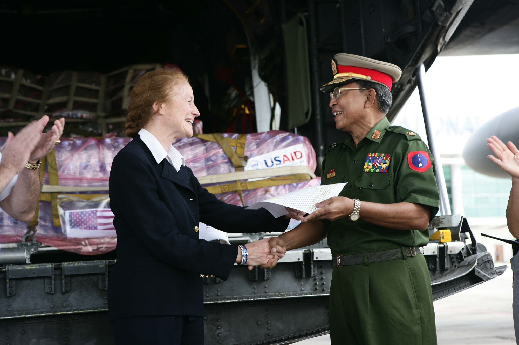 Henrietta H. Fore (left) meets an official at the Yangon International Airport May 12. The plane carried water, food and medical supplies to provide relief to Burma, which was struck by Cyclone Nargis May 2. Ms. Fore is an administrator for the U.S. Agency for International Development from the American People. (U.S. Marine Corps photo/Sgt. Andres Alcaraz)


