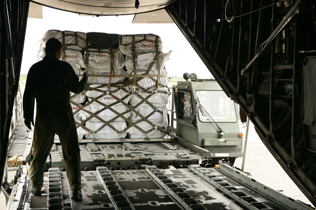 Supplies are loaded into a C-130 Hercules to deliver to the country of Burma May 12 at the Yangon International Airport. The plane carrying water, food and medical supplies provided relief to Burma, which was struck by Cyclone Nargis May 2. (U.S. Marine Corps photo/Sgt. Andres Alcaraz)