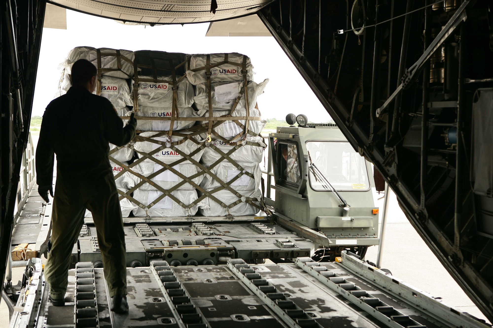 Supplies are loaded into a C-130 Hercules to deliver to the country of Burma May 12 at the Yangon International Airport. The plane carrying water, food and medical supplies provided relief to Burma, which was struck by Cyclone Nargis May 2. (U.S. Marine Corps photo/Sgt. Andres Alcaraz)