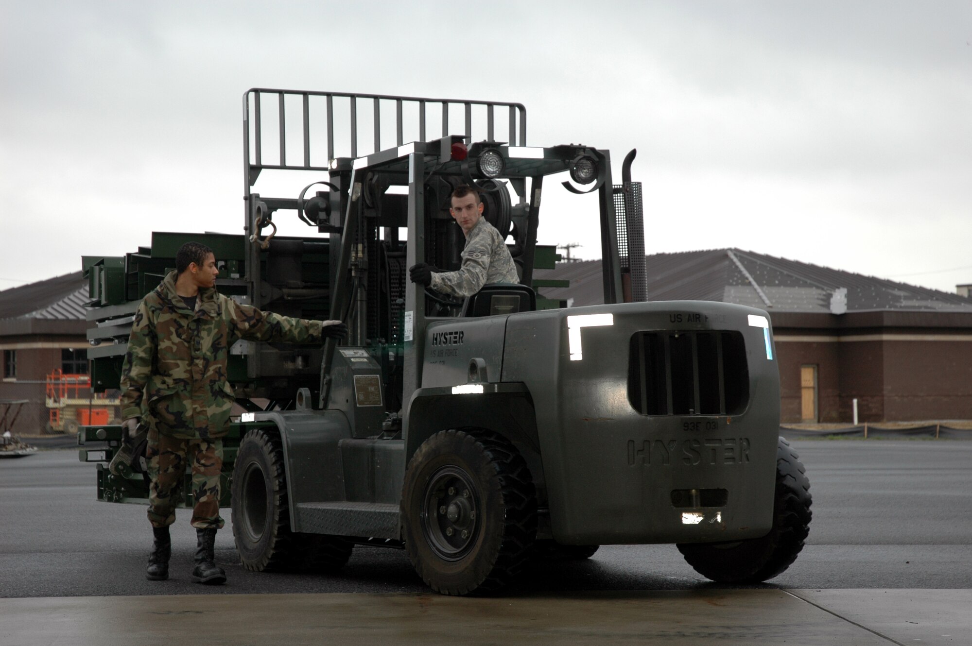 Airmen from the 816th Global Mobility Squadron, McGuire Air Force Base, N.J., use a forklift to move the deployable hydraulic lift for assembly as part of a demonstration for the lift with the Air Mobility Battlelab April 1, 2008, at McGuire.  The AMB, located in the U.S. Air Force Expeditionary Center on Fort Dix, N.J., coordinated the demonstration as part of the Deployable Hydraulic Lift Initiative which aims to help contingency response Airmen have an easier time moving cargo in deployed locations.  (U.S. Air Force Photo/Art Tollefson)