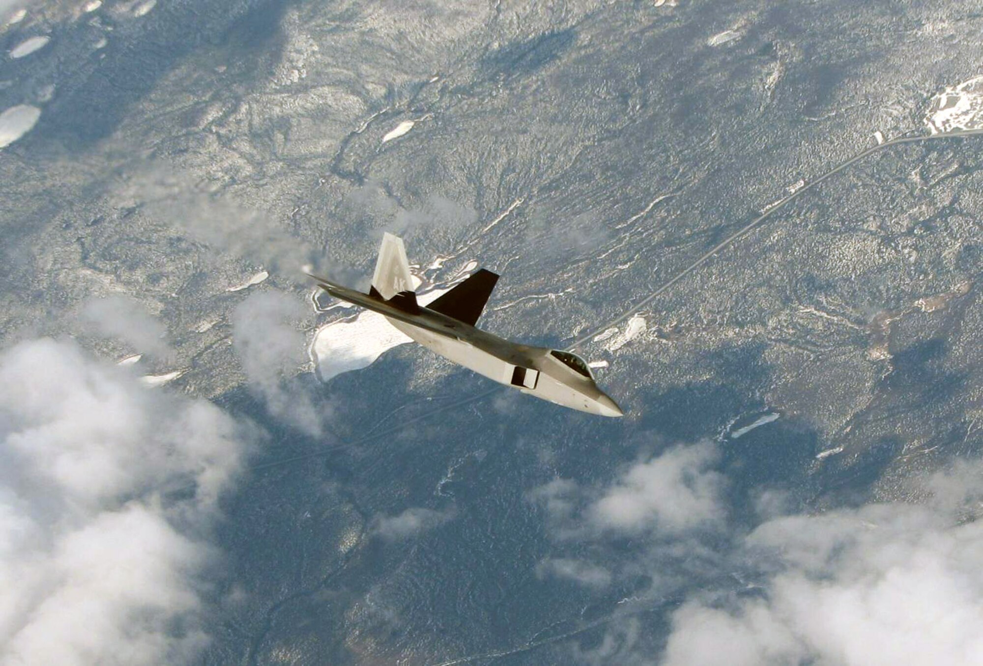 An F-22 Raptor from the 3rd Wing at Elmendorf Air Force Base, Alaska, rejoins the fight after refueling during Northern Edge 2008 May 8. Twelve Elmendorf AFB F-22s were part of the more than 120 aircraft participating in the largest military training exercise in Alaska. An Alaska Air National Guard KC-135 Stratotanker from Eielson Air Force Base, Alaska's, 168th Air Refueling Wing delivered the fuel during the refueling mission. (U.S. Air Force photo/Tech. Sgt. Mikal Canfield) 