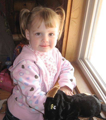 Kyndal Hitchcock, 3, plays with a dog puppet at the window of the Hill Air Force Base Log Cabin during the Family Child Care Provider Picnic May 10. The puppet was one of many goodies inside a cooler gift bag that all FCC Providers were presented at the party. (U.S. Air Force Photo by Tech. Sgt. Jason Smith)