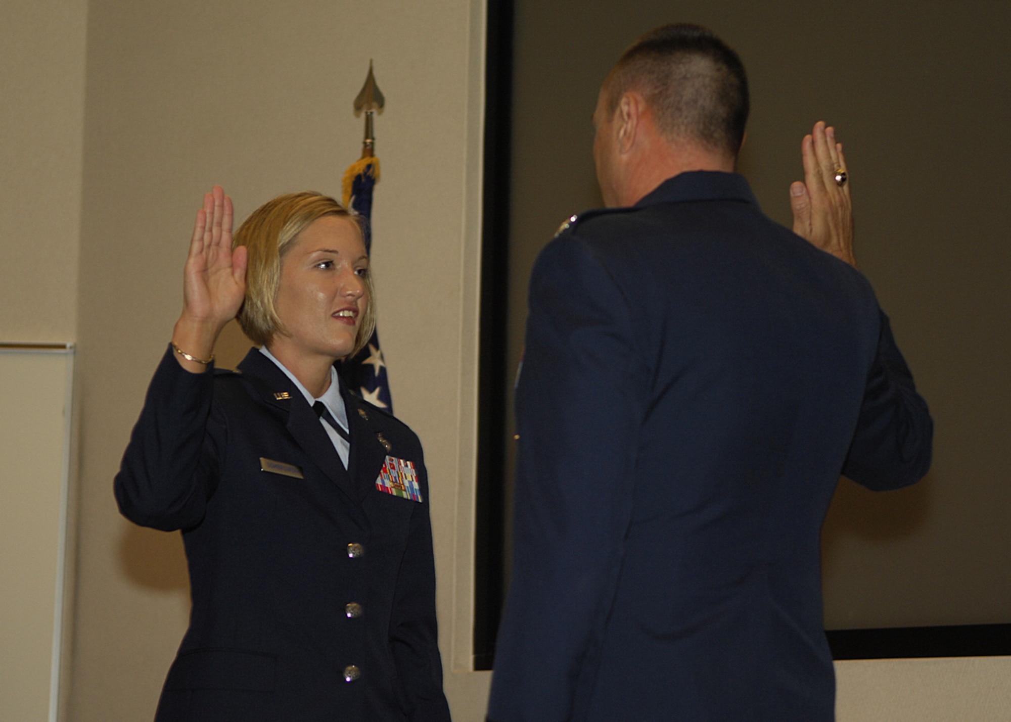 MOODY AIR FORCE BASE, Ga. -- Col. Don Derry, 820th Security Forces Group commander, swears in 2nd Lt. Keara Dombrowski during a commisioning ceremony at Valdosta State University's Hugh Bailey Science Center Auditorium.  Lieutenant Dombrowski spent the first six years of her Air Force career as an enlisted Airmen and two more as a cadet in the Reserve Officer Training Corps. (U.S. Air Force photo by Senior Airman Elizabeth Rissmiller)