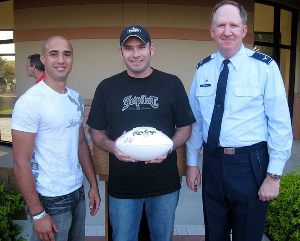Col. Michael McCully, 482nd Mission Support Group commander, presents two members of the winning base intramural flag football team with a memento during the Homestead Services’ barbeque and awards presentation for all personnel who participated in base organized athletic leagues on May 2. All participants were invited to feast on barbeque-style dinner, and members of winning teams in each league received customized gifts. The events aimed to thank everyone for their participation in the leagues and to help build camaraderie off of the playing field. (Courtesy photo)