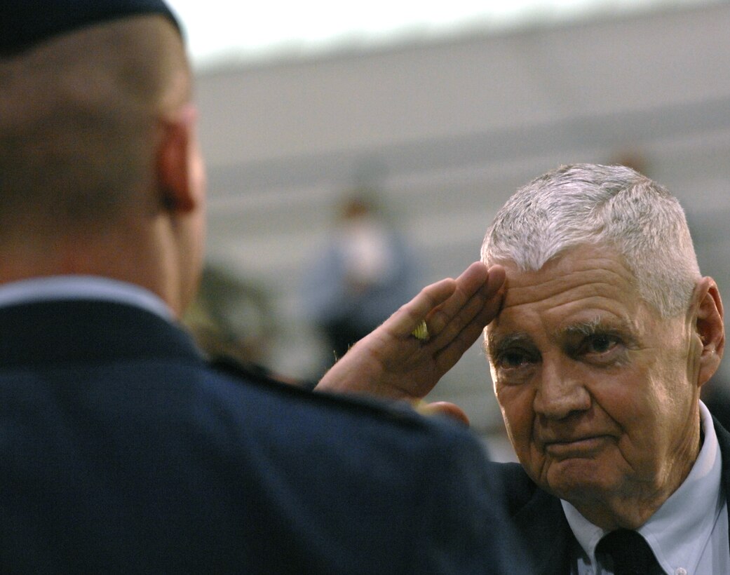 Former Air Force Staff Sgt. John O'Connor gives a first salute to his grandson, 2nd Lt. Patrick O'Connor, during the Norwich University graduation ceremony in Northfield, Vt., May 10, 2008.