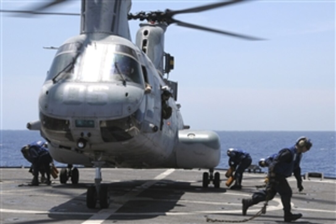 U.S. Navy seamen remove restraining chains, May 10, 2008, from a Sea Knight helicopter on the amphibious dock landing ship USS Harpers Ferry, which is part of the USS Essex Expeditionary Strike Group positioned to support Burmese victims of Cyclone Nargis and a tidal wave.