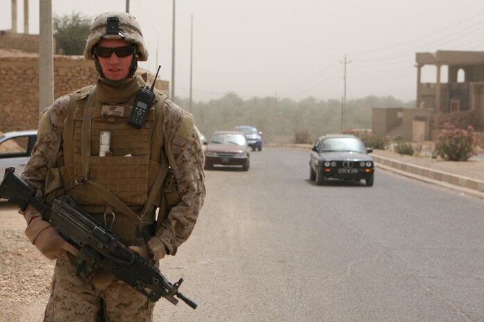 Lance Cpl. Sonny M. Olivera, 20, a rifleman from Camarillo, Calif., assigned to Company K, 3rd Battalion, 4th Marine Regiment, Regimental Combat Team 5, patrols through Haditha, Iraq, May 13. Marines conducted the security patrol with an Iraqi policeman.  The Marines try to take policemen on their patrols as much as possible to teach them how to patrol the correct way.
