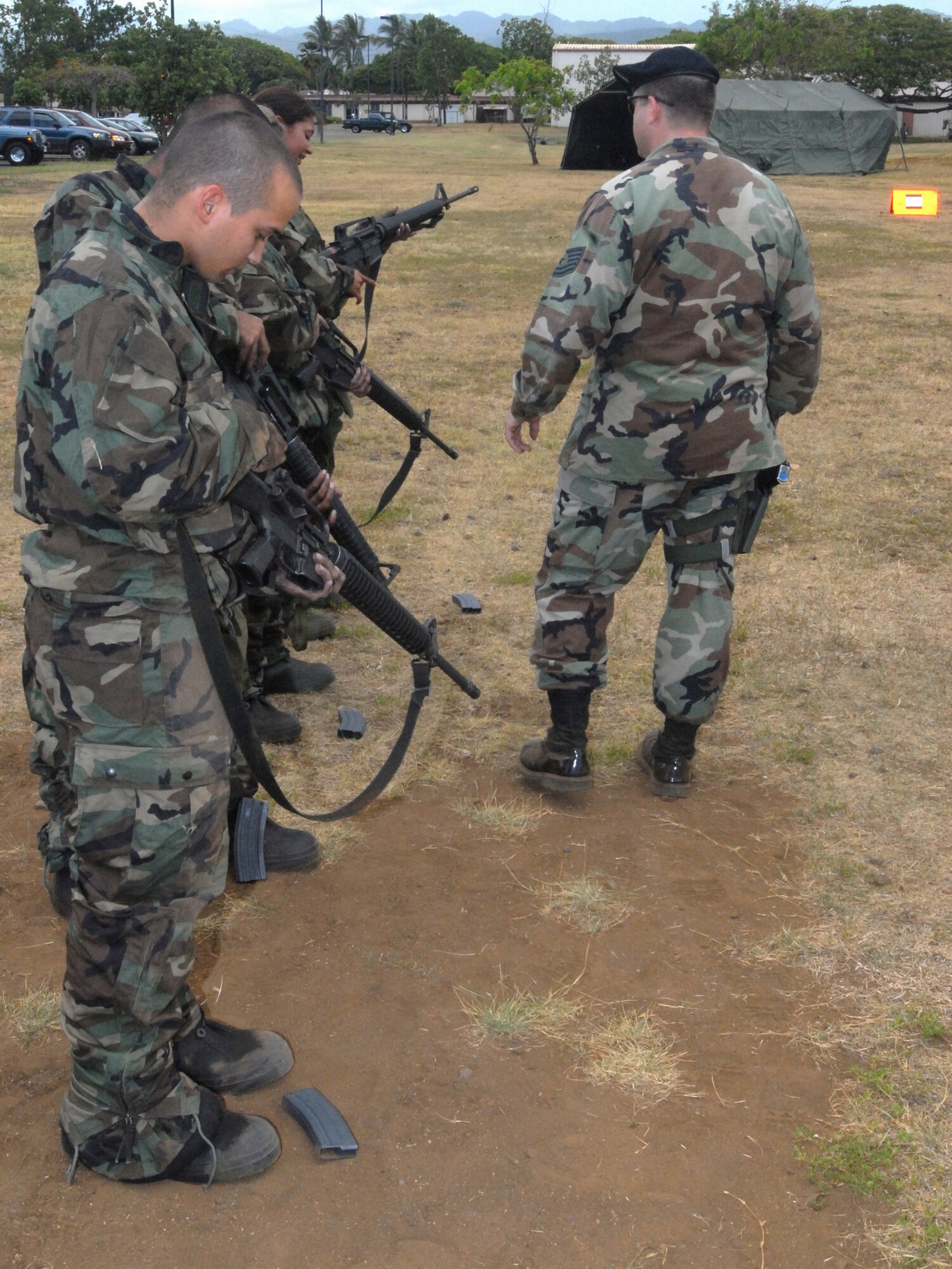 Hickam warriors review weapons safety and clearing procedures during the Ability to Survive and Operate portion of an exercise here. The exercise is in preparation for the upcoming Operational Readiness Inspection. (U.S. Air Force Photo/Senior Master Sgt. Russell Dodson.)