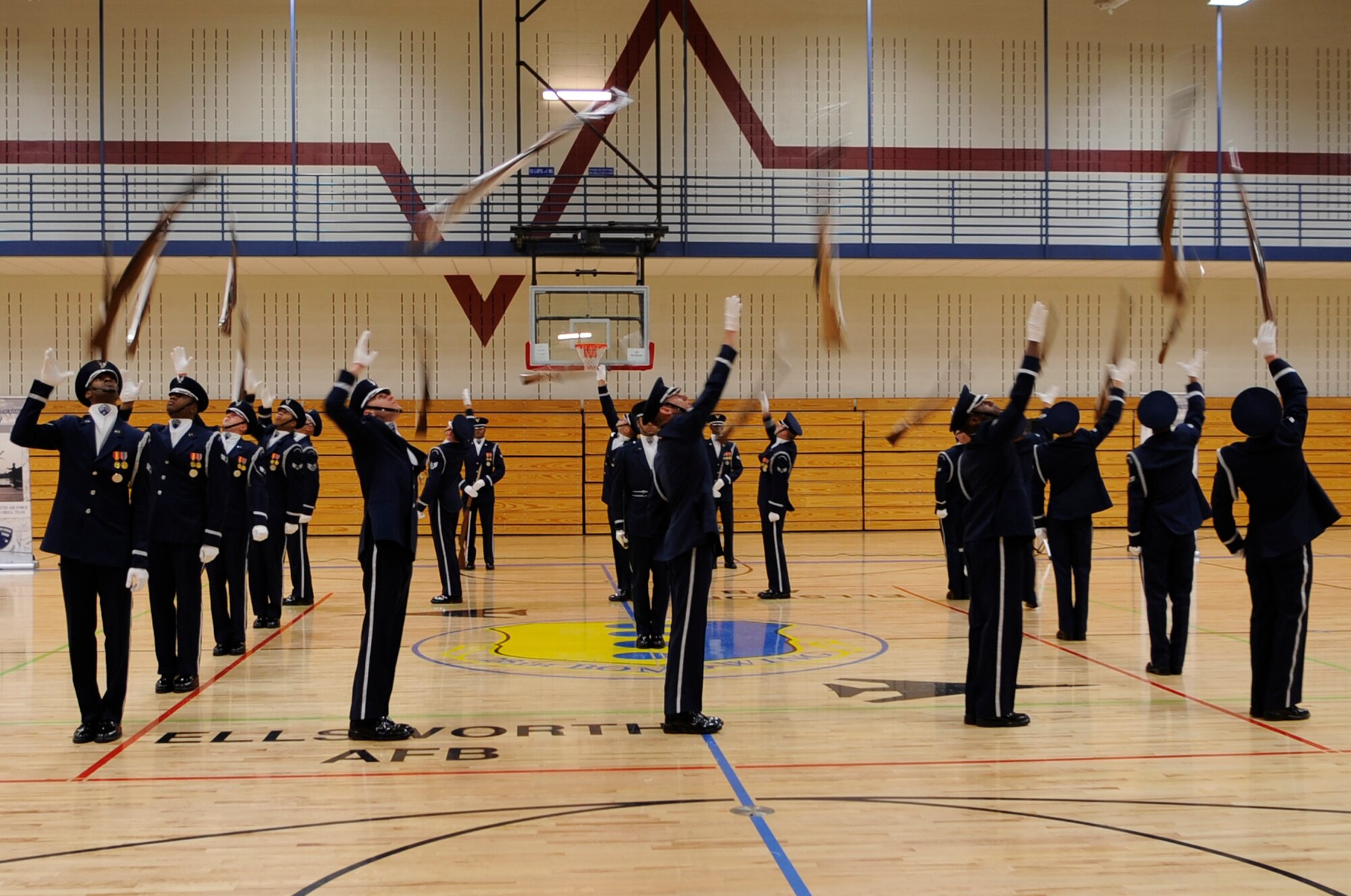 The Air Force Honor Guard Drill Team toss their rifles to team members behind them in a square formation during a performance here, May 12, as part of their Northern Tier Tour. The Air Force Honor Guard Drill Team tours world-wide to public and military venues to recruit, retain and inspire Airmen. (U.S. Air Force photo by Airman 1st Class Kasey Zickmund)