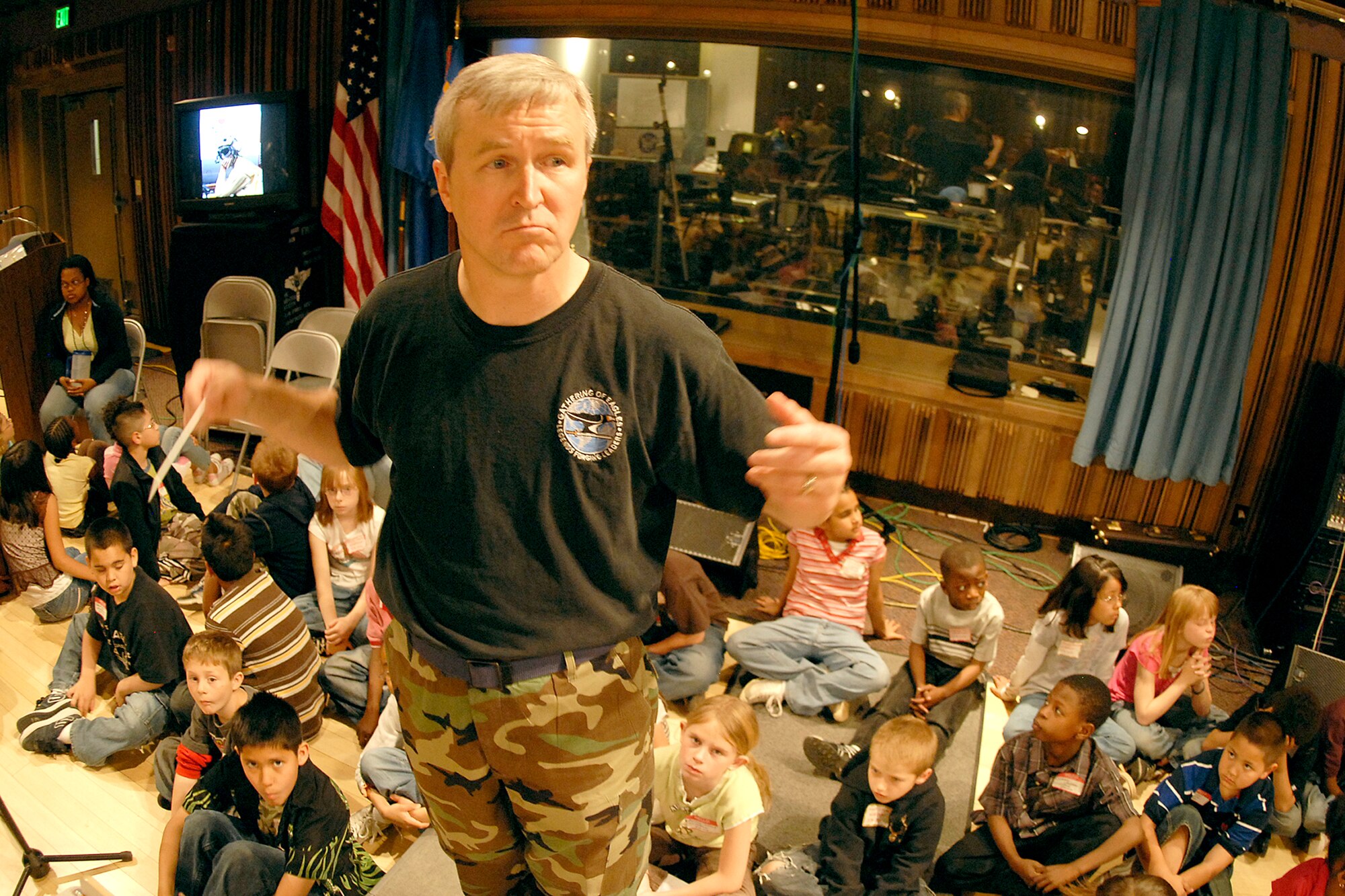 Lt. Col. Larry Lang, U.S. Air Force Academy Band commander and conductor, leads the band in practice May 9 while students from local Colorado Springs Wildflower Elementary School listen on. The USAFA band's outreach program has regular visits from local schools to visit the band's practices, learning about music, military history and current events. (U.S. Air Force photo/Rob Bussard)