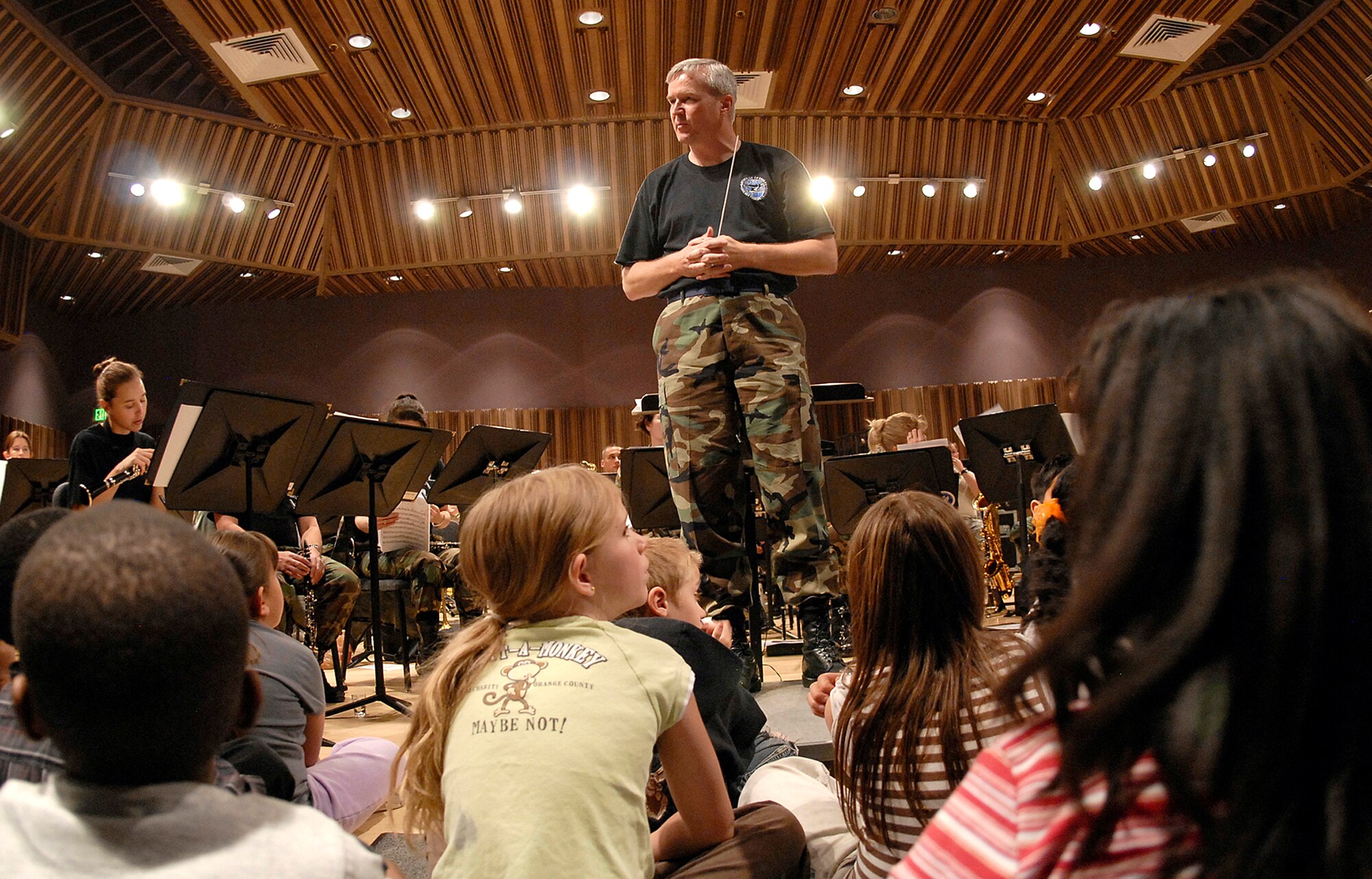 Lt. Col. Larry Lang, U.S. Air Force Academy Band commander and conductor, defines the importance of military band music to students from local Colorado Springs Wildflower Elementary School May 9. The USAFA band's outreach program has regular visits from local schools to visit the band's practices, learning about music, military history and current events. (U.S. Air Force photo/Rob Bussard)