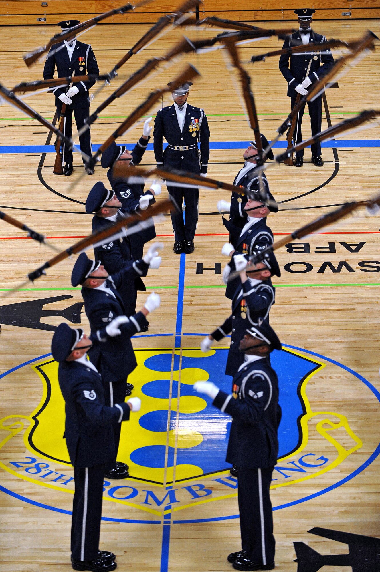 The Air Force Honor Guard Drill Team performs a 16-man routine at the Bellamy Fitness Center May 12 during their Northern Tier Tour. The Air Force Honor Guard Drill Team tours world-wide to public and military venues to recruit, retain and inspire Airmen. (U.S. Air Force photo/Senior Airman Marc I. Lane)