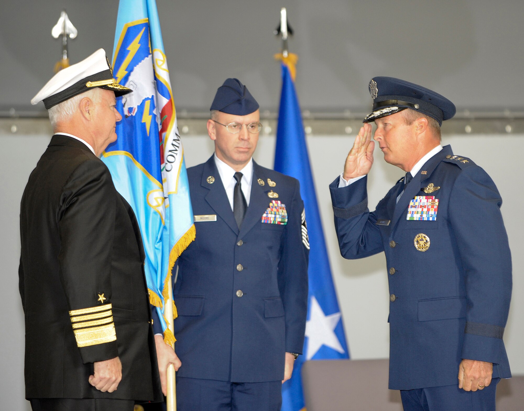 ELMENDORF AIR FORCE BASE, ALASKA -- Admiral Timothy Keating, Commander, U.S. Pacific Command, (left) completes the assumption of command ceremony for Alaskan Command (ALCOM) with ALCOM Chief Master Sgt. Robert Moore (center) and new commander of ALCOM, Lieutenant General Dana Atkins (right) May 9 here. (U.S. Air Force photo by Master Sgt. Keith Brown)